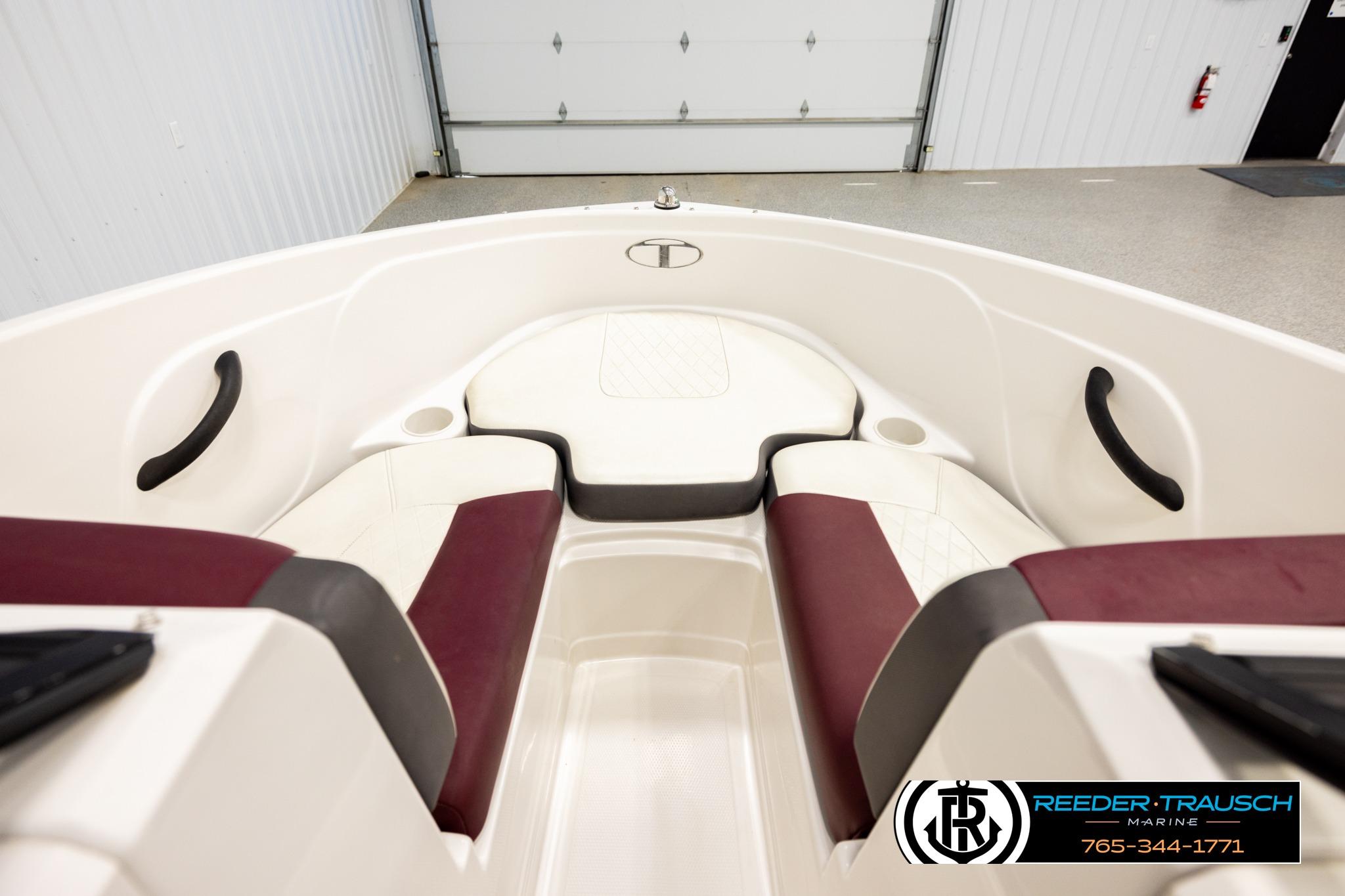 Interior view of a 2016 Tahoe 450 TS boat with maroon and white seating.