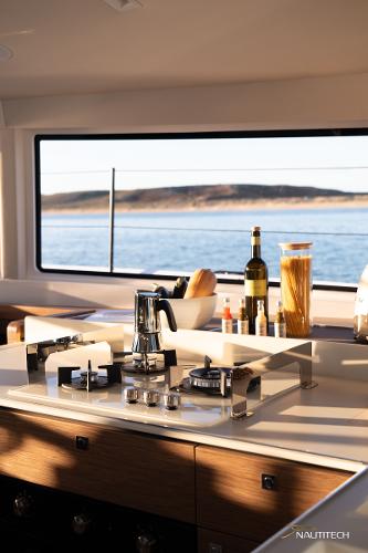Modern kitchen interior of 2025 Nautitech 48 Open yacht with ocean view.