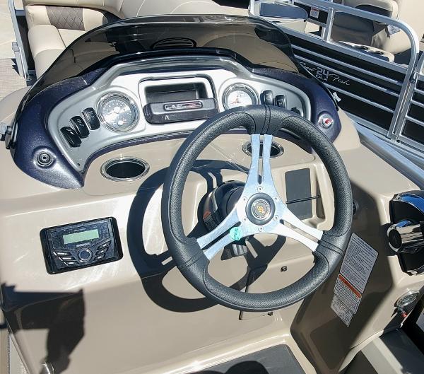 2023 Sun Tracker SportFish 22 XP3 boat dashboard with steering wheel and control panel.