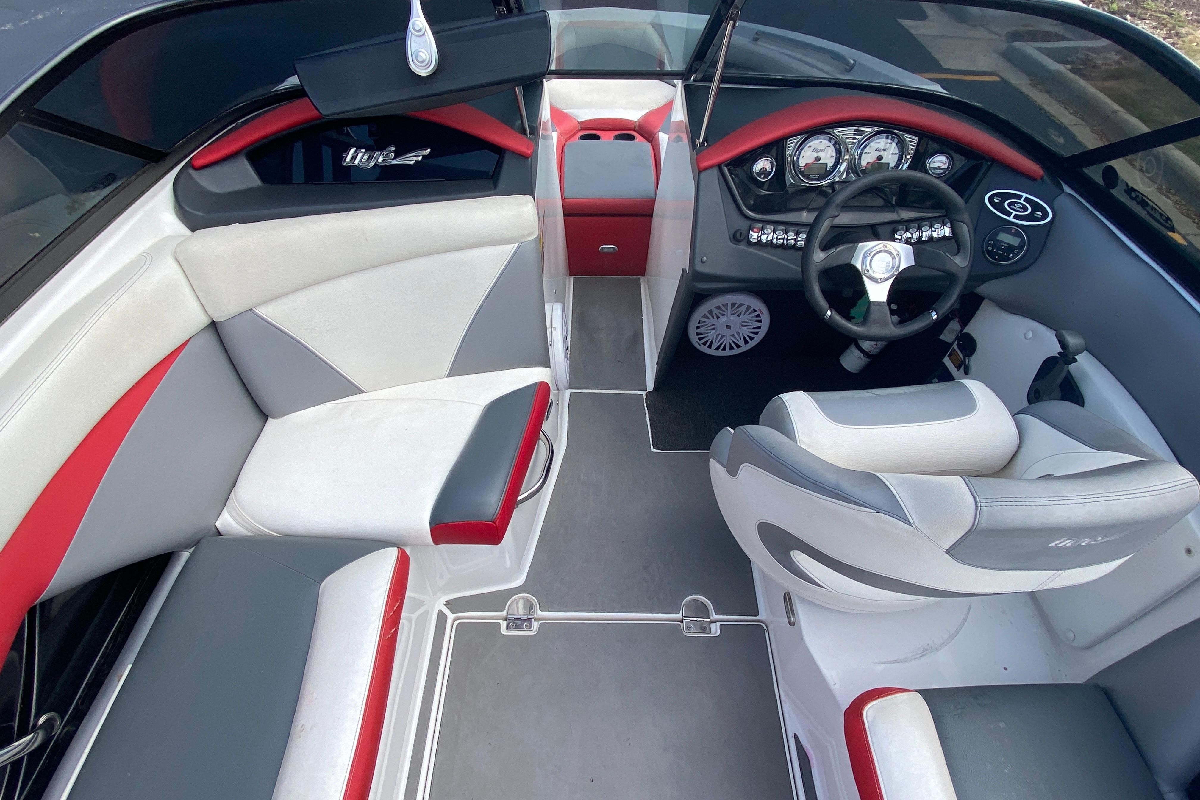 2014 Tigé R20 boat interior with red, gray, and white seating and modern dashboard.