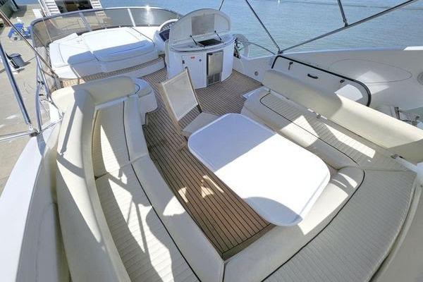 Luxurious Sunseeker Manhattan 66 yacht deck with seating and dining area, 2005 model.