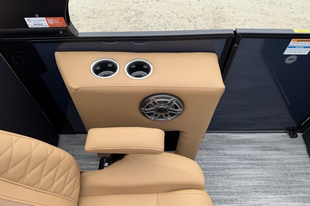 2026 Godfrey Monaco 235 SFLC iMPACT boat interior with beige seating and cup holders.
