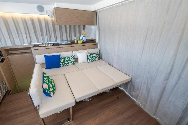 Interior of 2025 Lagoon 43 yacht with modern seating and colorful cushions.