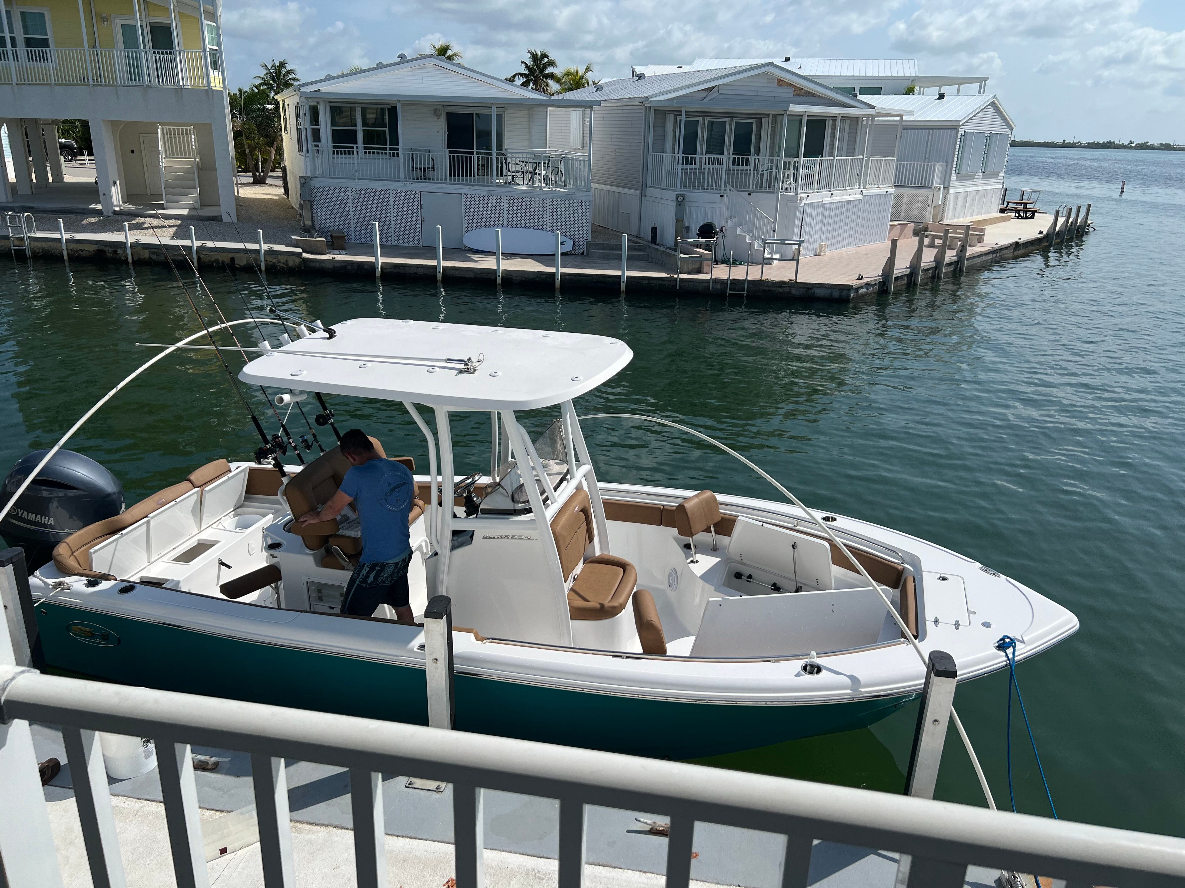 2022 Sea Hunt Ultra 234 boat docked with fishing gear.