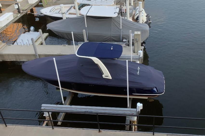 2025 Chris-Craft Launch 28 GT boat docked with cover on water.