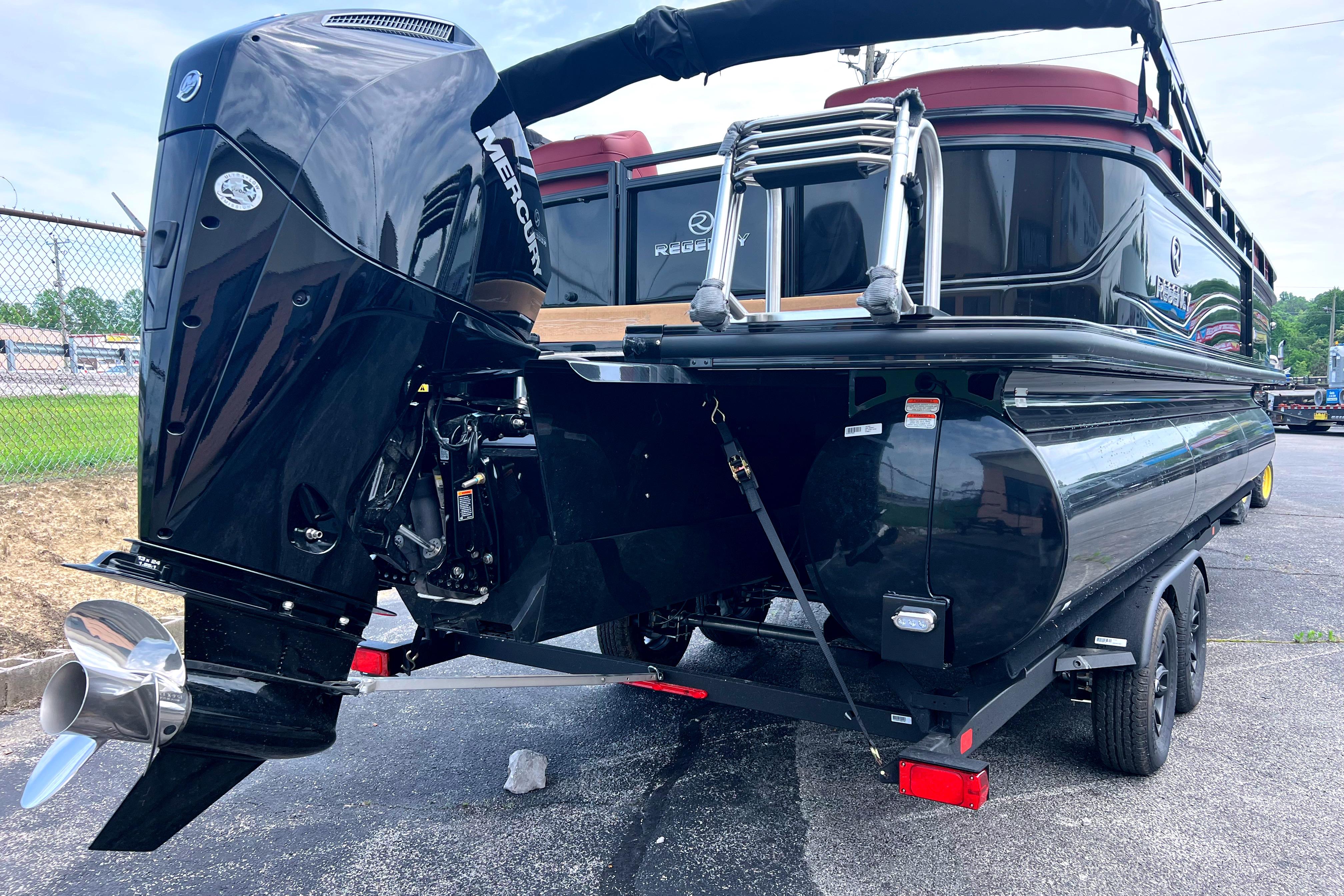 2026 Regency 230 DL pontoon boat with Mercury outboard motor on trailer.