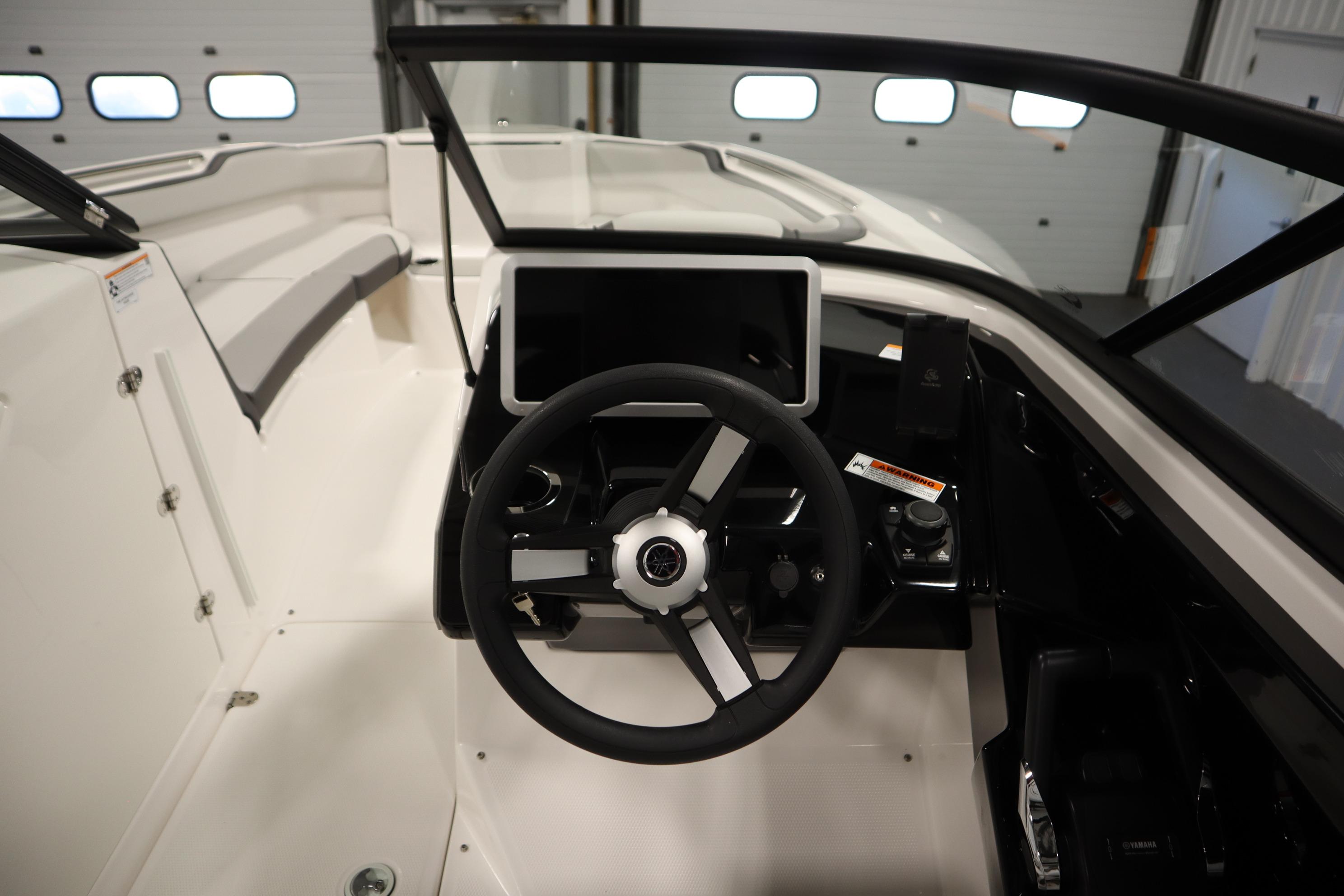2026 Yamaha Boats AR250 cockpit with steering wheel and modern dashboard controls.