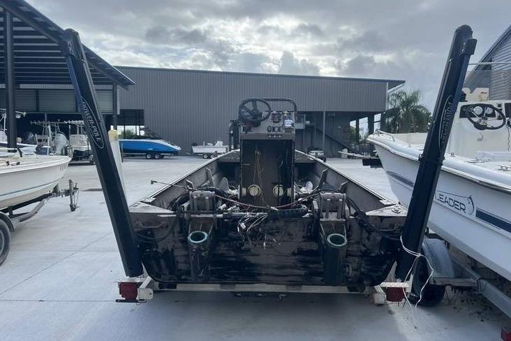 2016 Pro-Drive X Series 20' boat in a marina, rear view with overcast sky.