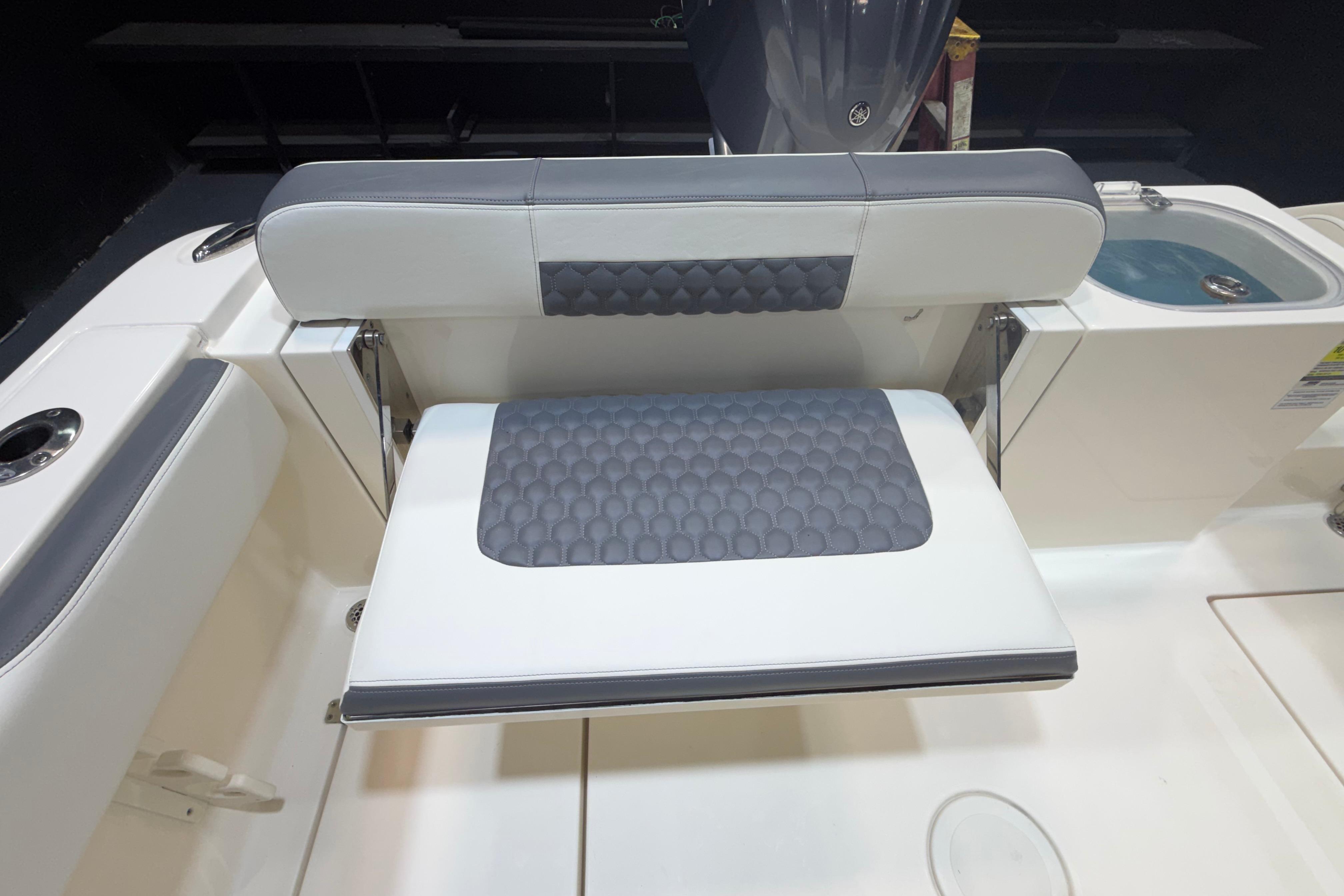 2023 Cobia 237 Center Console boat seat with gray and white cushioned design.