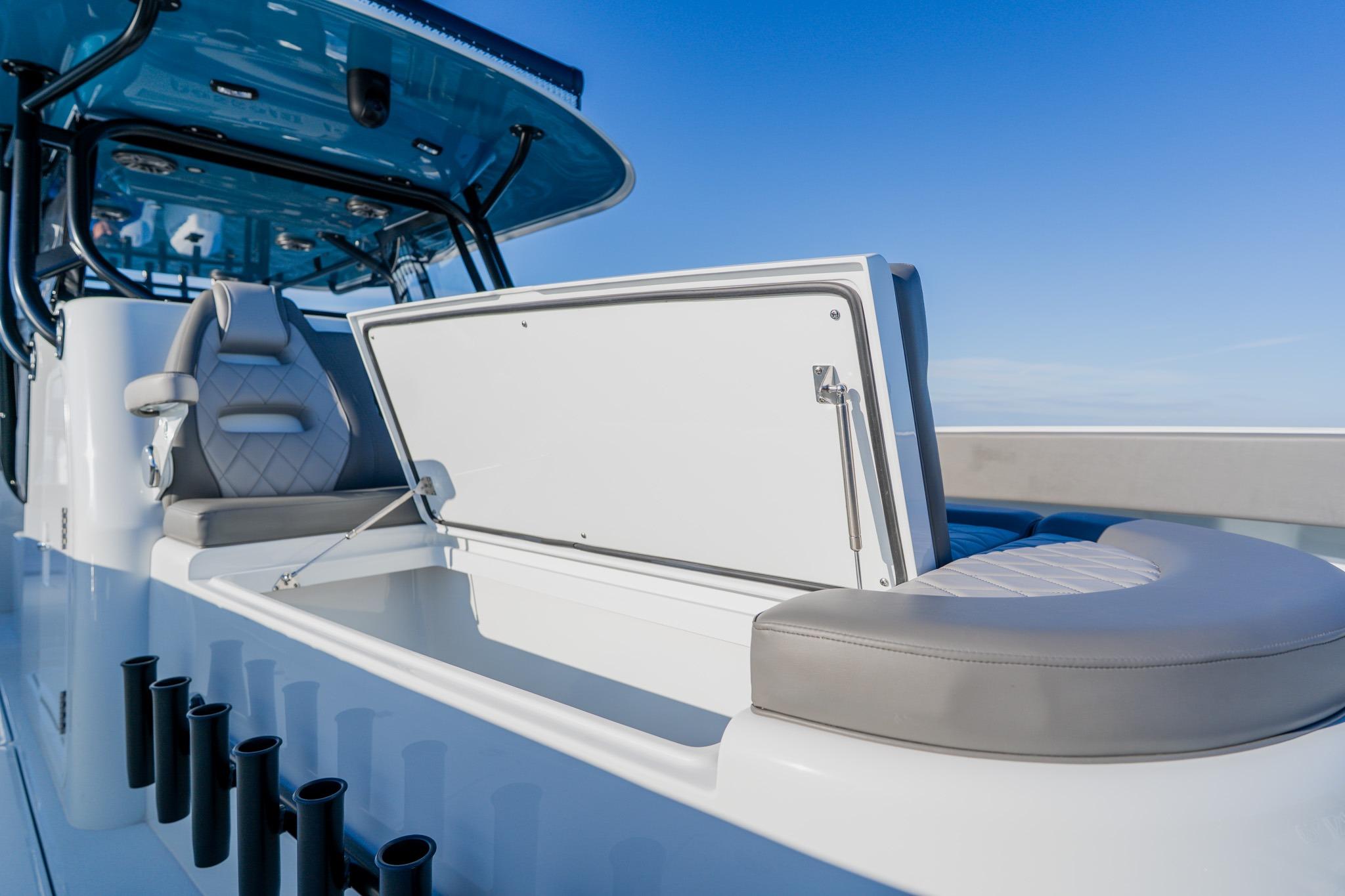 2025 Freeman 42LR boat interior with seating and storage, under clear blue sky.