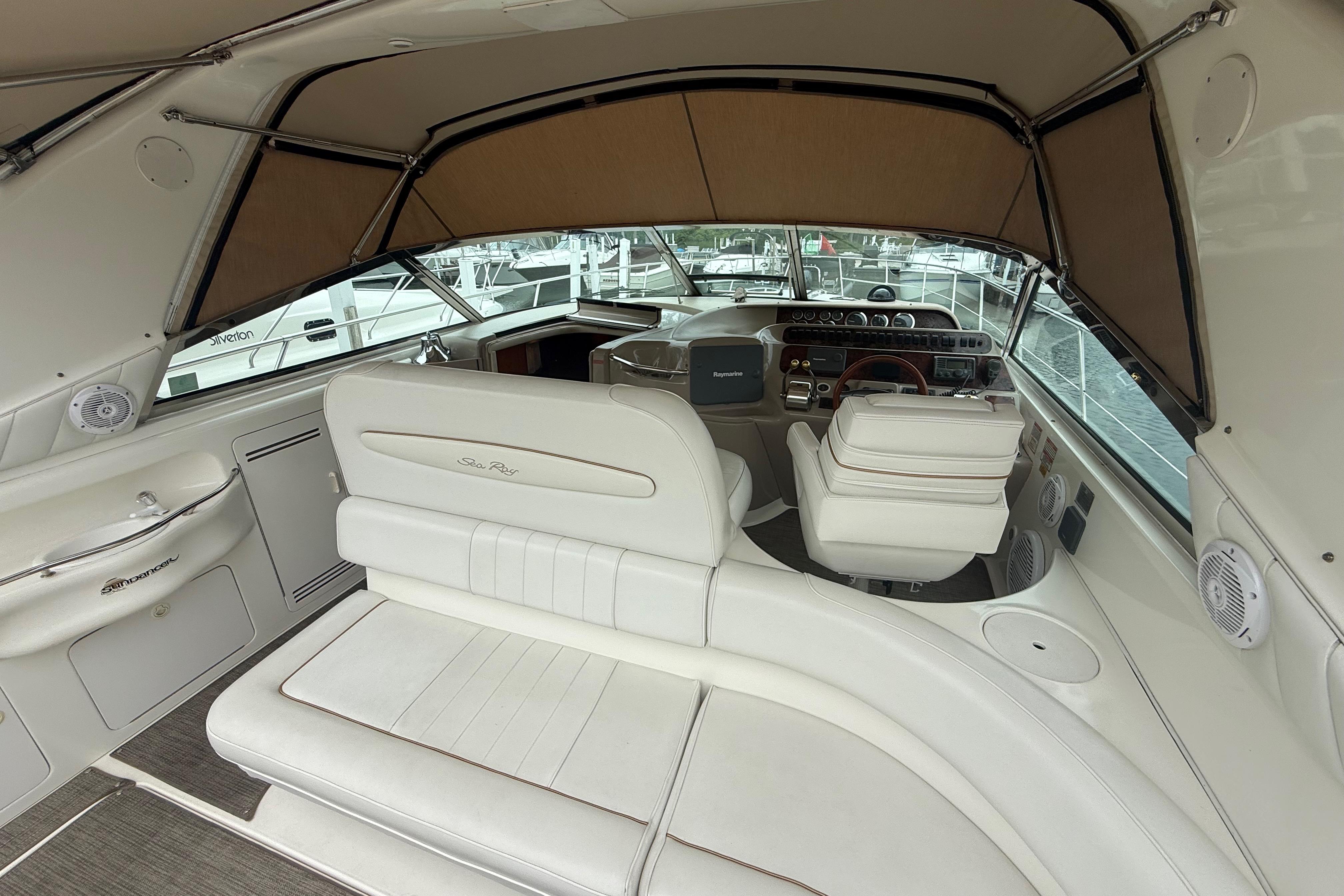 Interior of a 1998 Sea Ray Sundancer 400 yacht with white seating and helm.