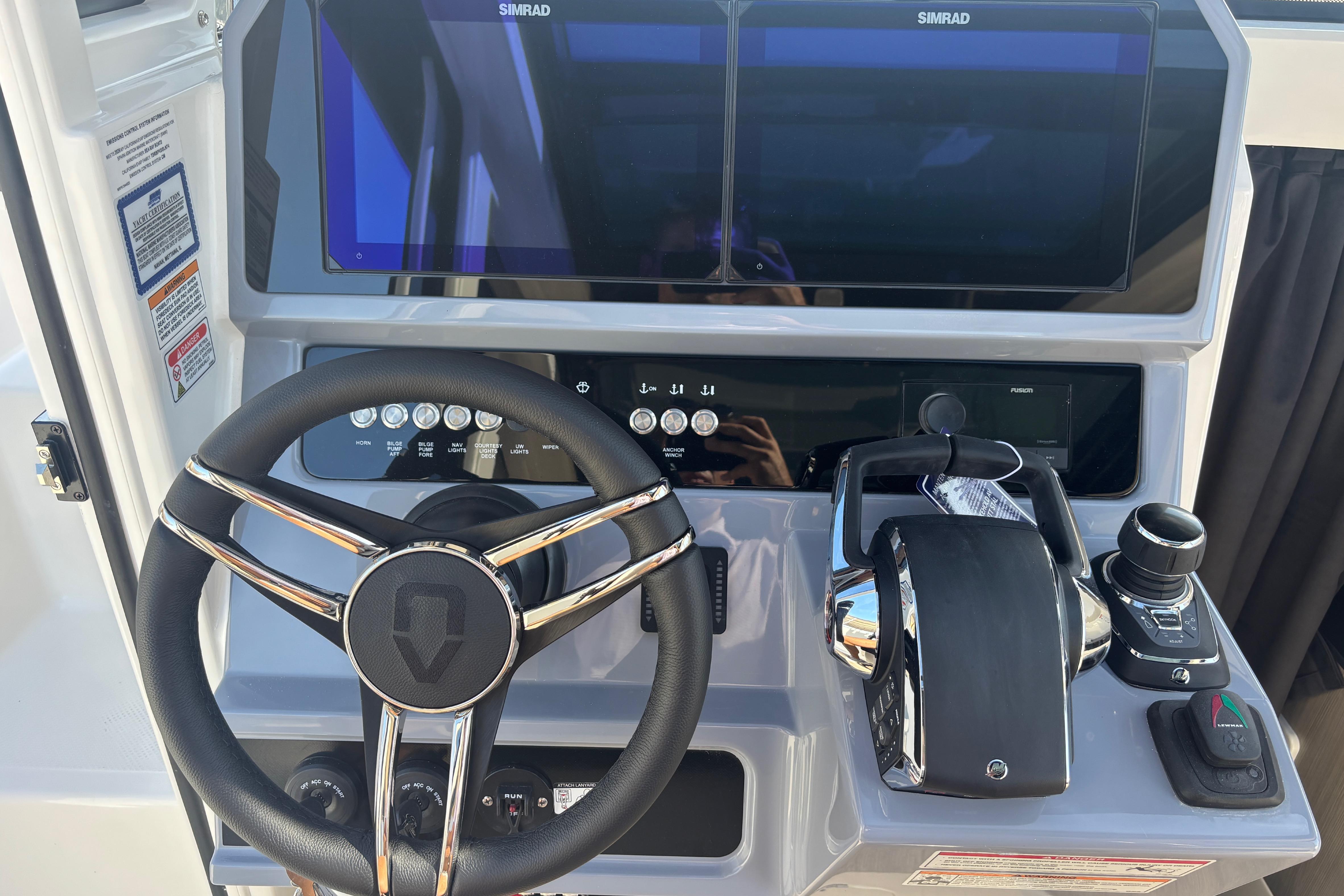 Steering console of 2026 Navan C30 boat with advanced controls and dual screens.