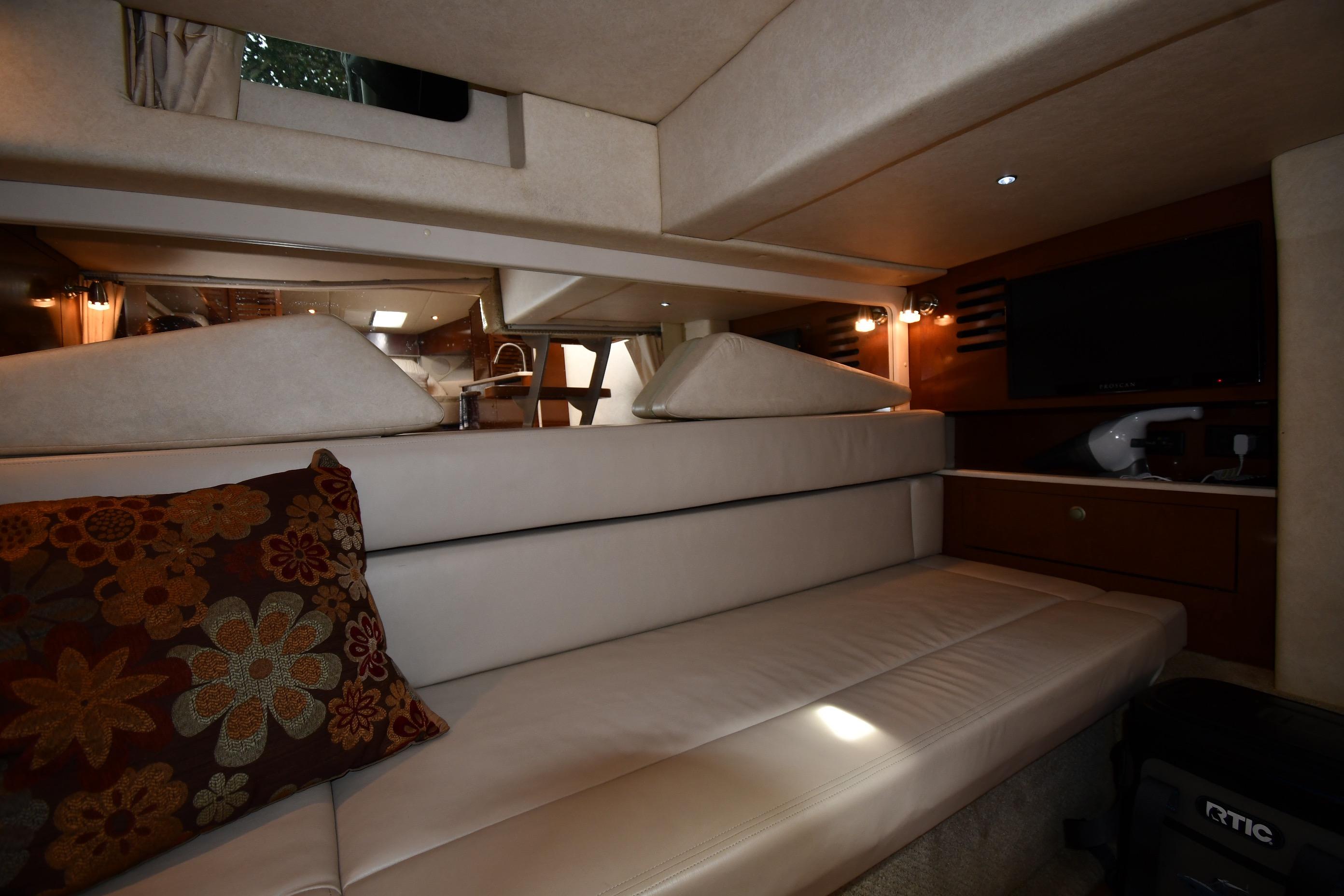 Luxurious interior of 2008 Sea Ray Sundancer 350 yacht with plush seating and elegant decor.