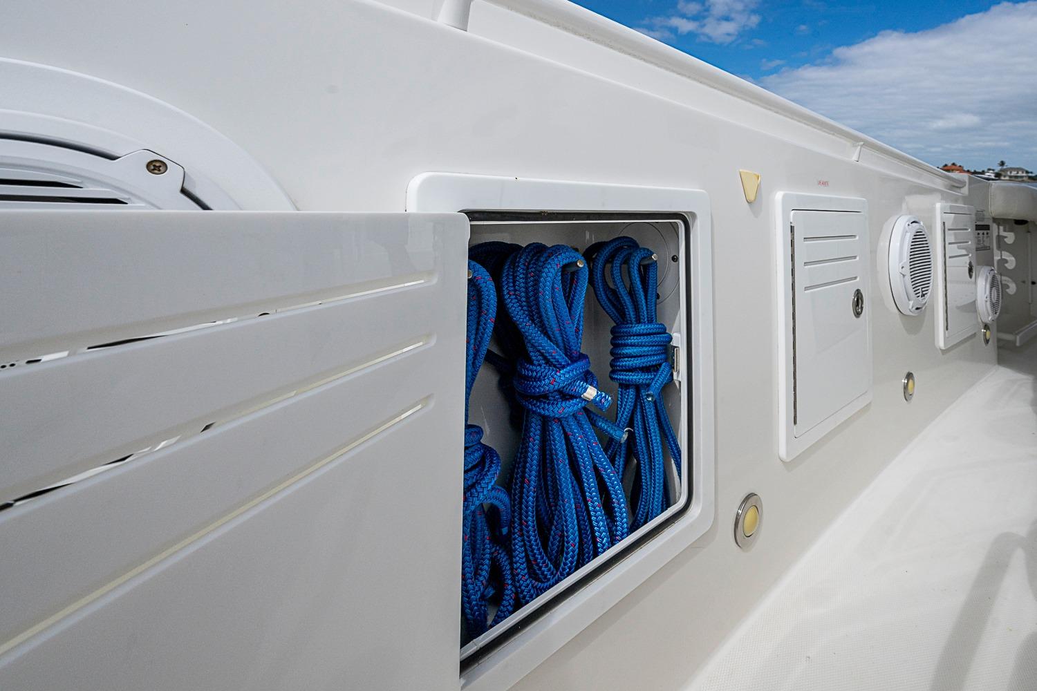 Storage compartment with blue ropes on a 2009 Everglades 350 Center Console boat.