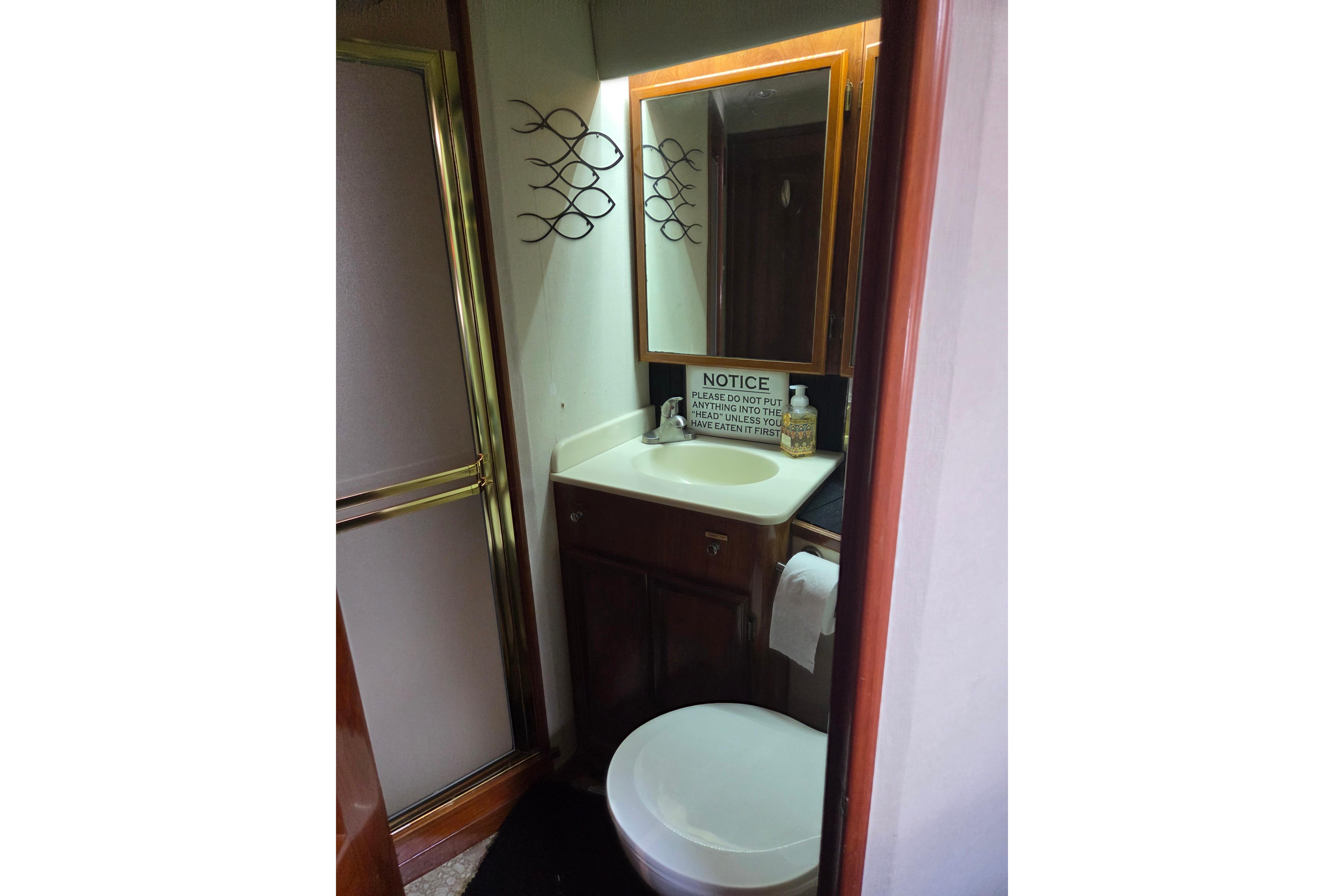 Bathroom interior of 1990 Egg Harbor Golden Egg 42 yacht with shower and sink.