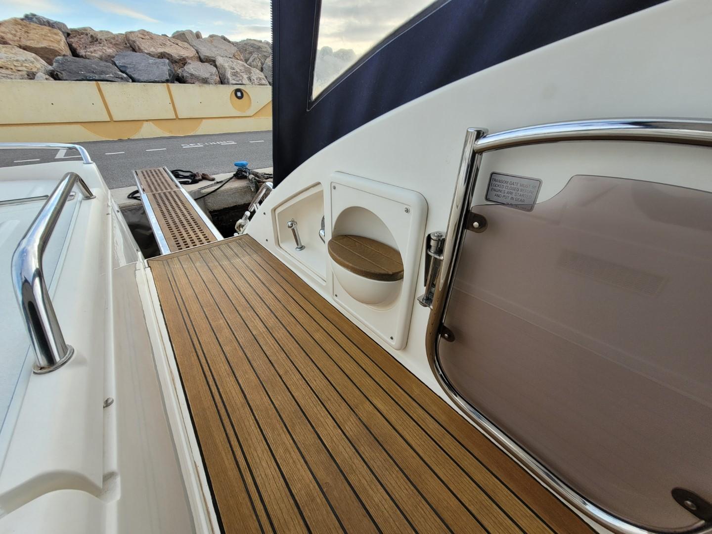 Fairline Targa 43 yacht deck, 2004 model, featuring sleek wood finish and modern design elements.