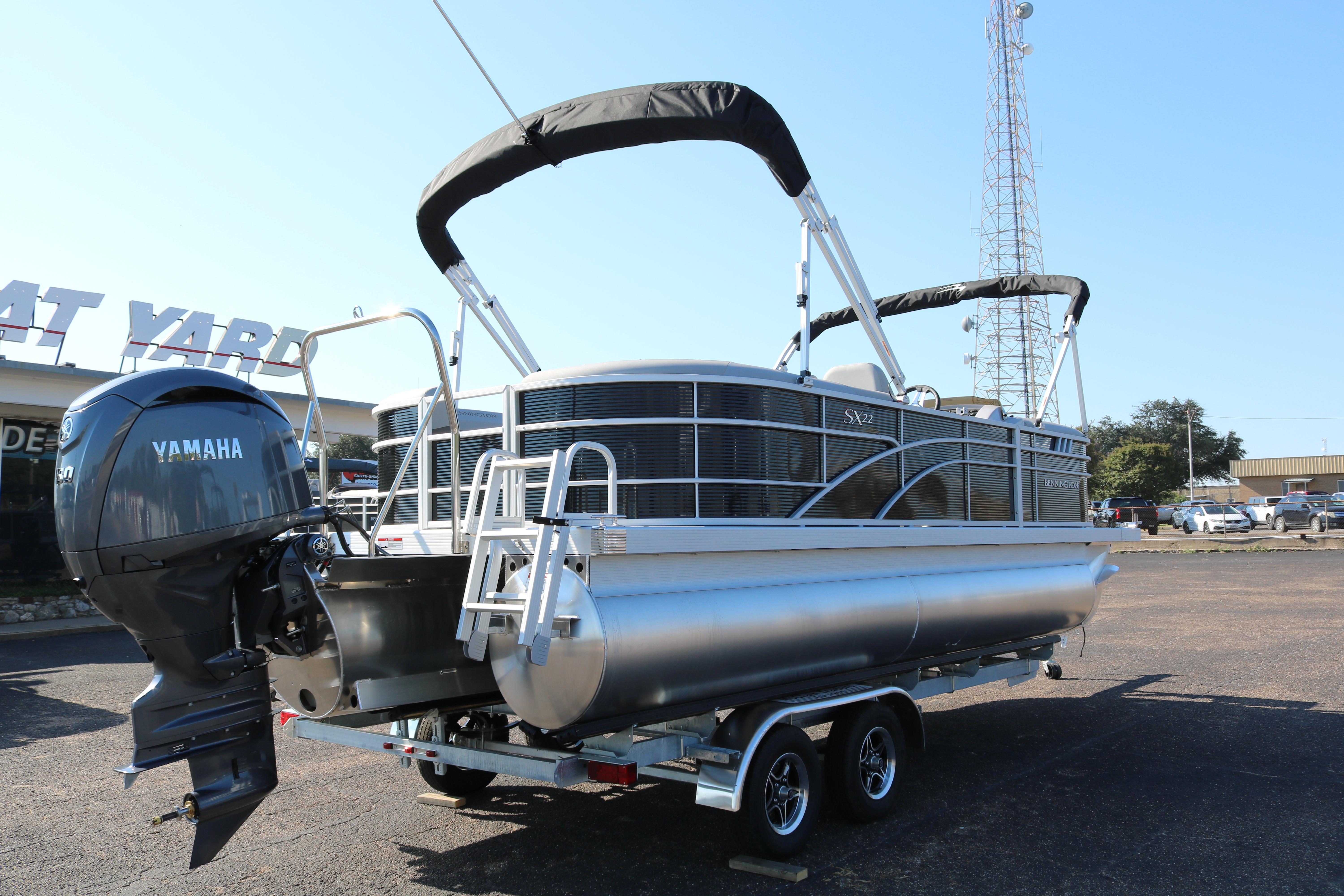 2026 Bennington 22SX Stern Radius pontoon boat with Yamaha outboard motor on trailer.