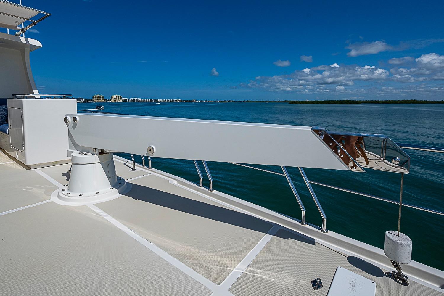 Deck view of 2014 Marlow 80 Explorer yacht with clear blue sky and ocean.