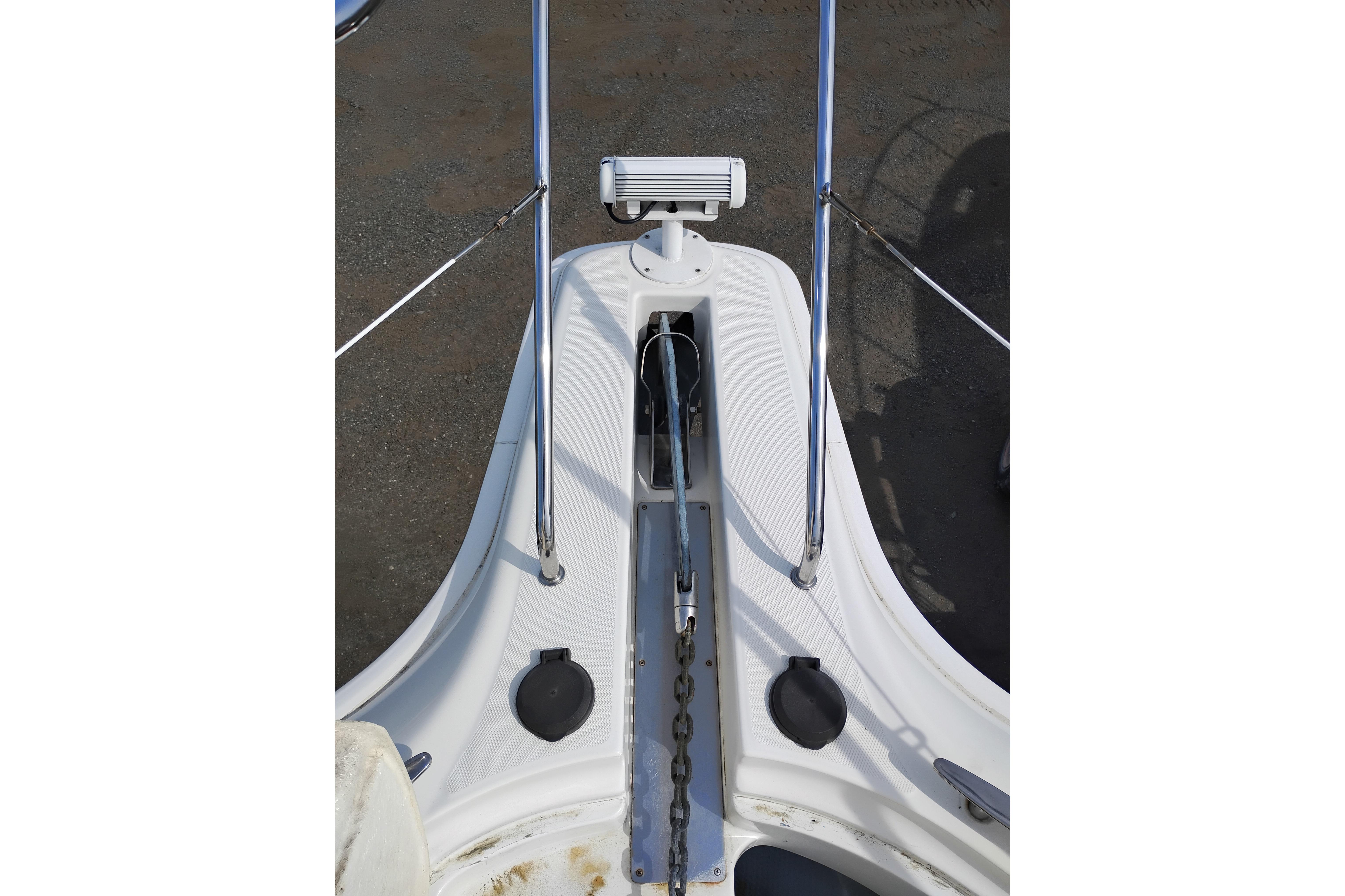 Bow of 2005 Silverton 38 Convertible boat with anchor chain and railing.