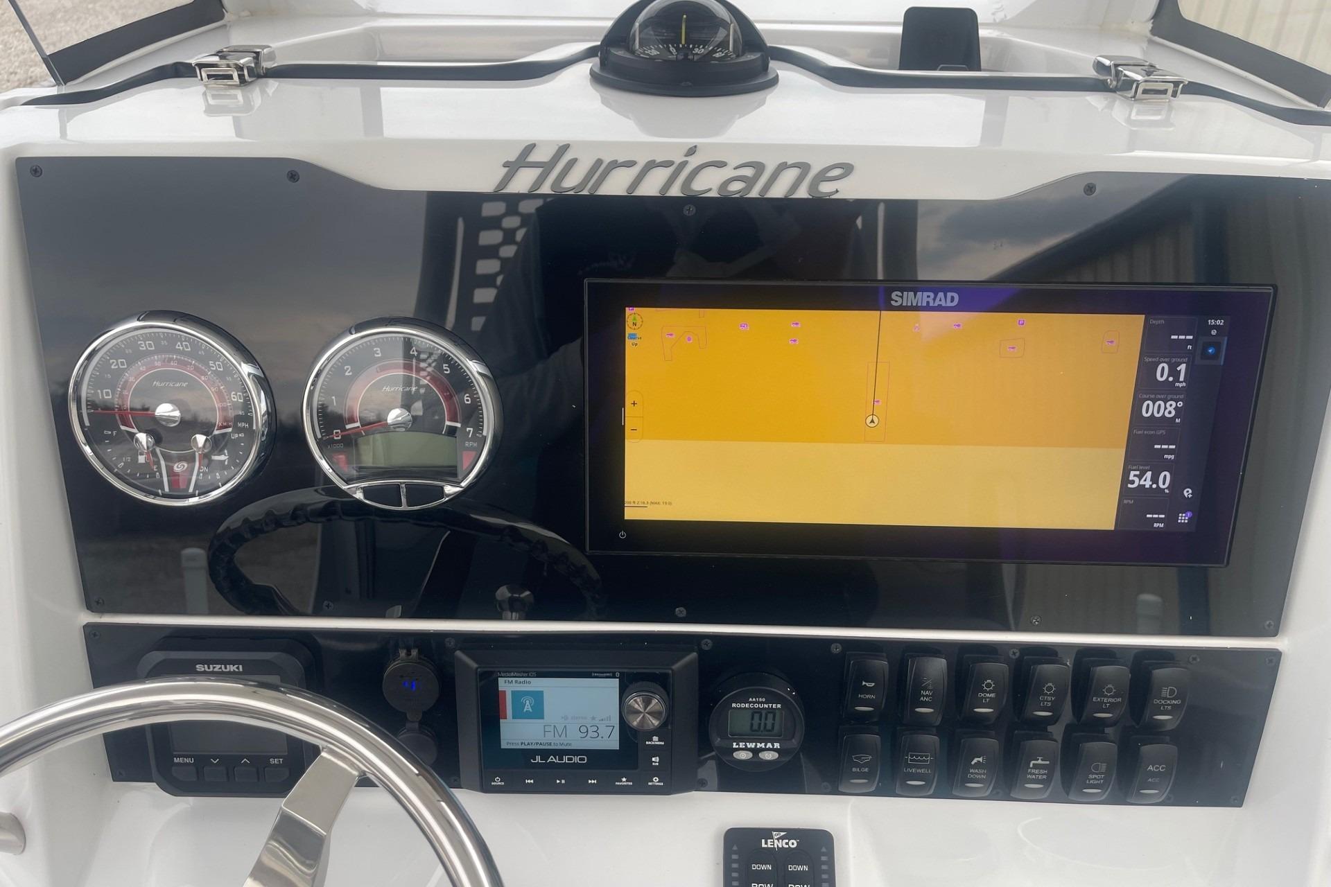 2025 Hurricane Center Console 24 OB dashboard with Simrad display and gauges.