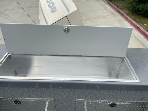 Storage compartment on a 2025 Spartan 200 Astoria vehicle, featuring a metal interior.