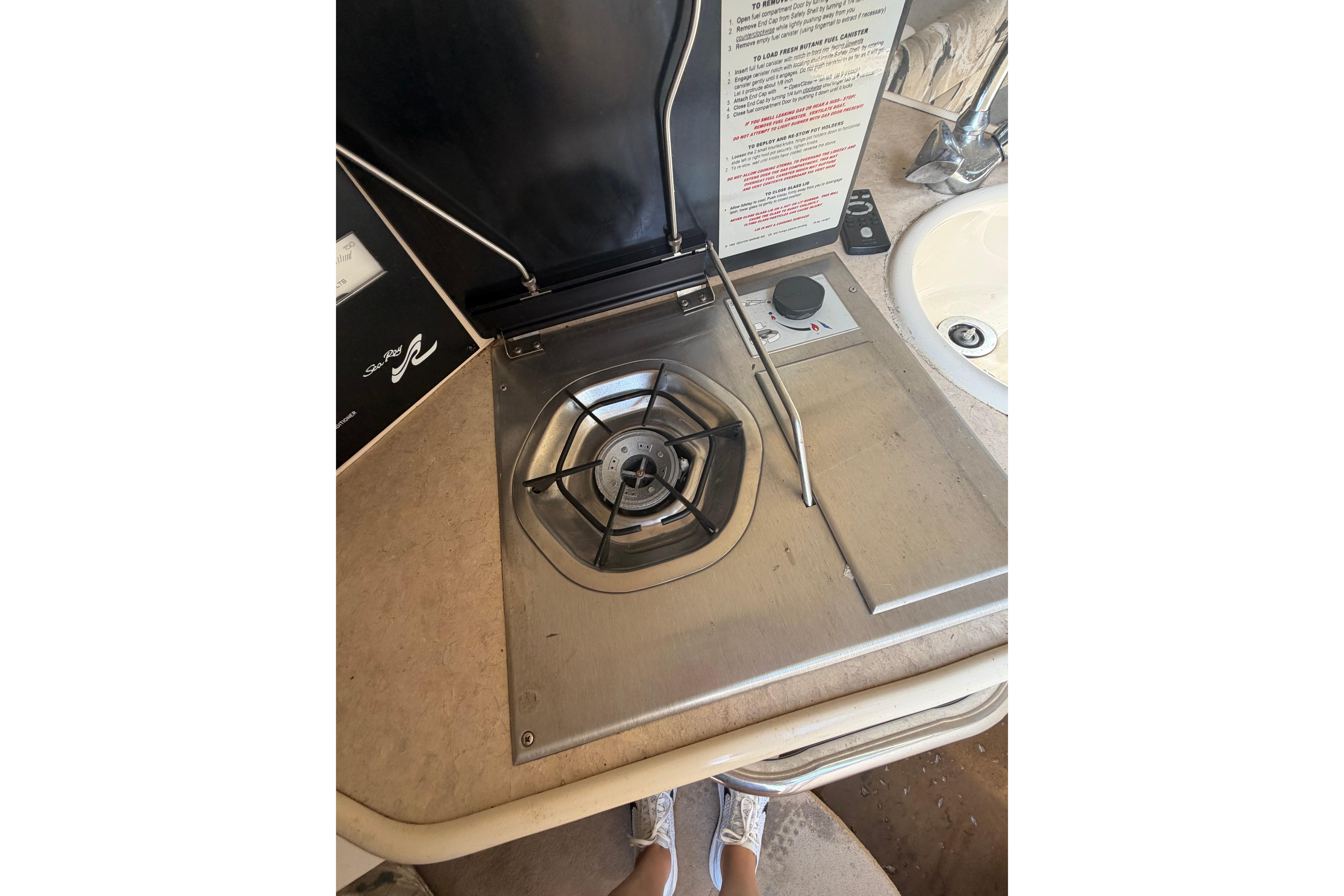 1999 Sea Ray 240 Sundancer boat stove and sink area, featuring a compact design.