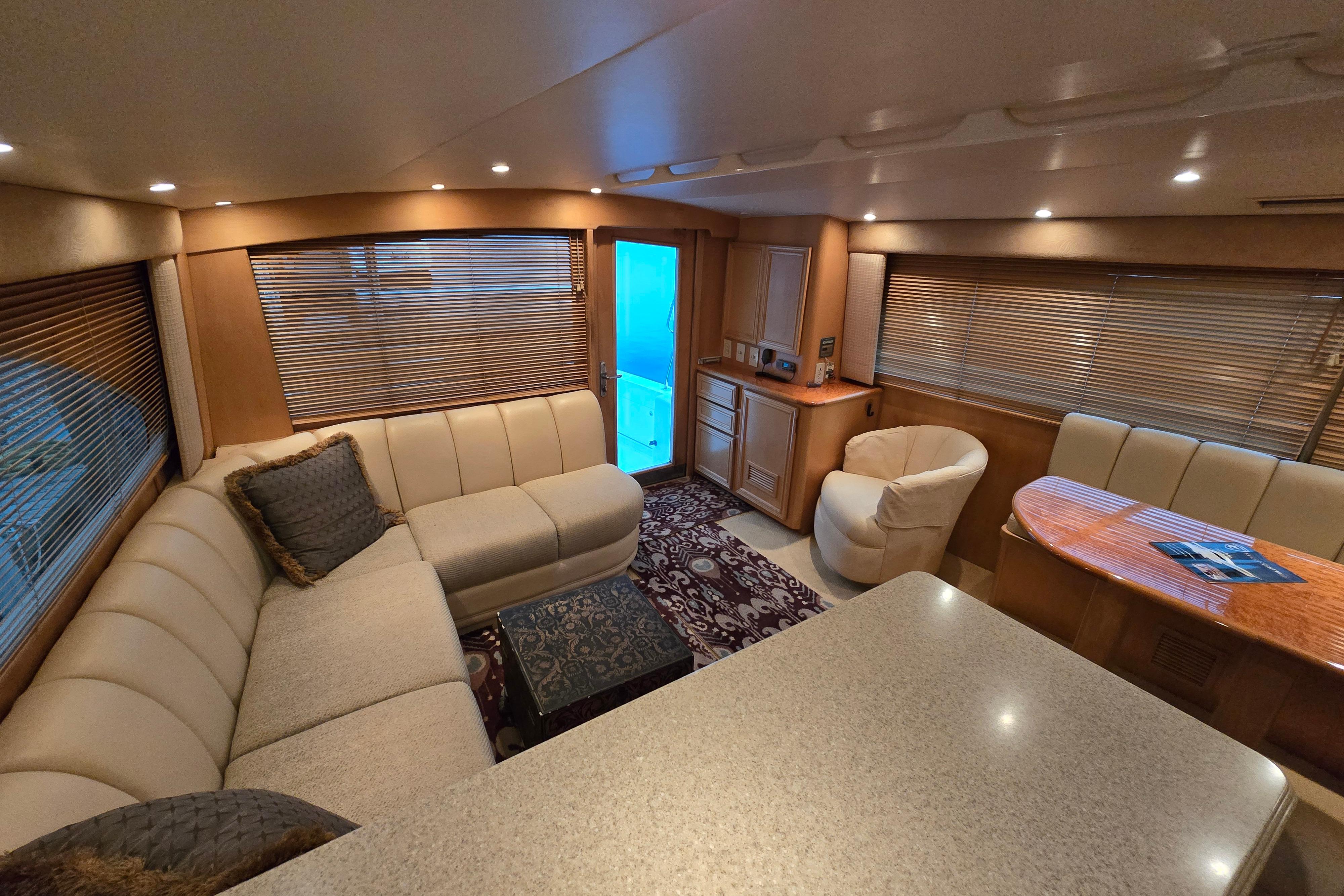 Luxurious interior of a 2001 Cavileer 53 Convertible yacht with plush seating and elegant decor.