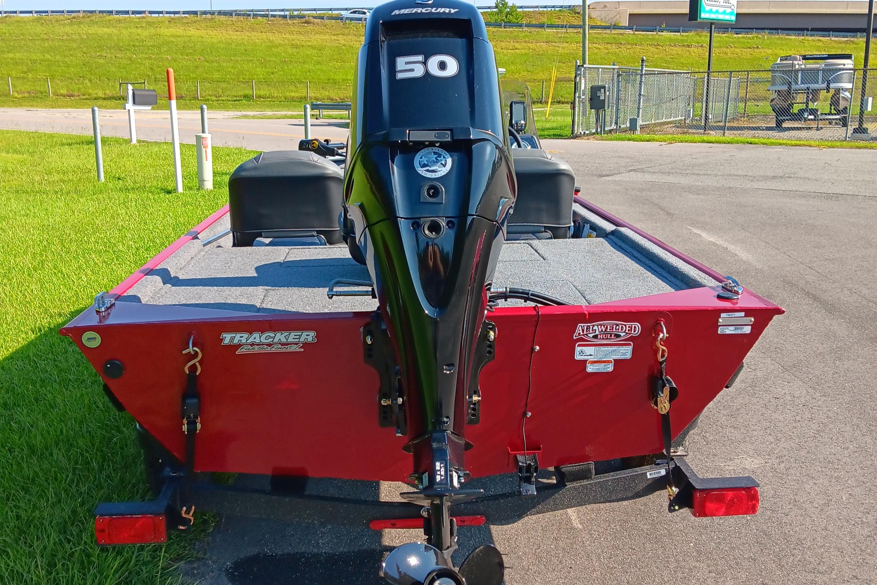 2026 Tracker Bass Tracker Classic XL boat with Mercury 50 engine, parked on pavement.
