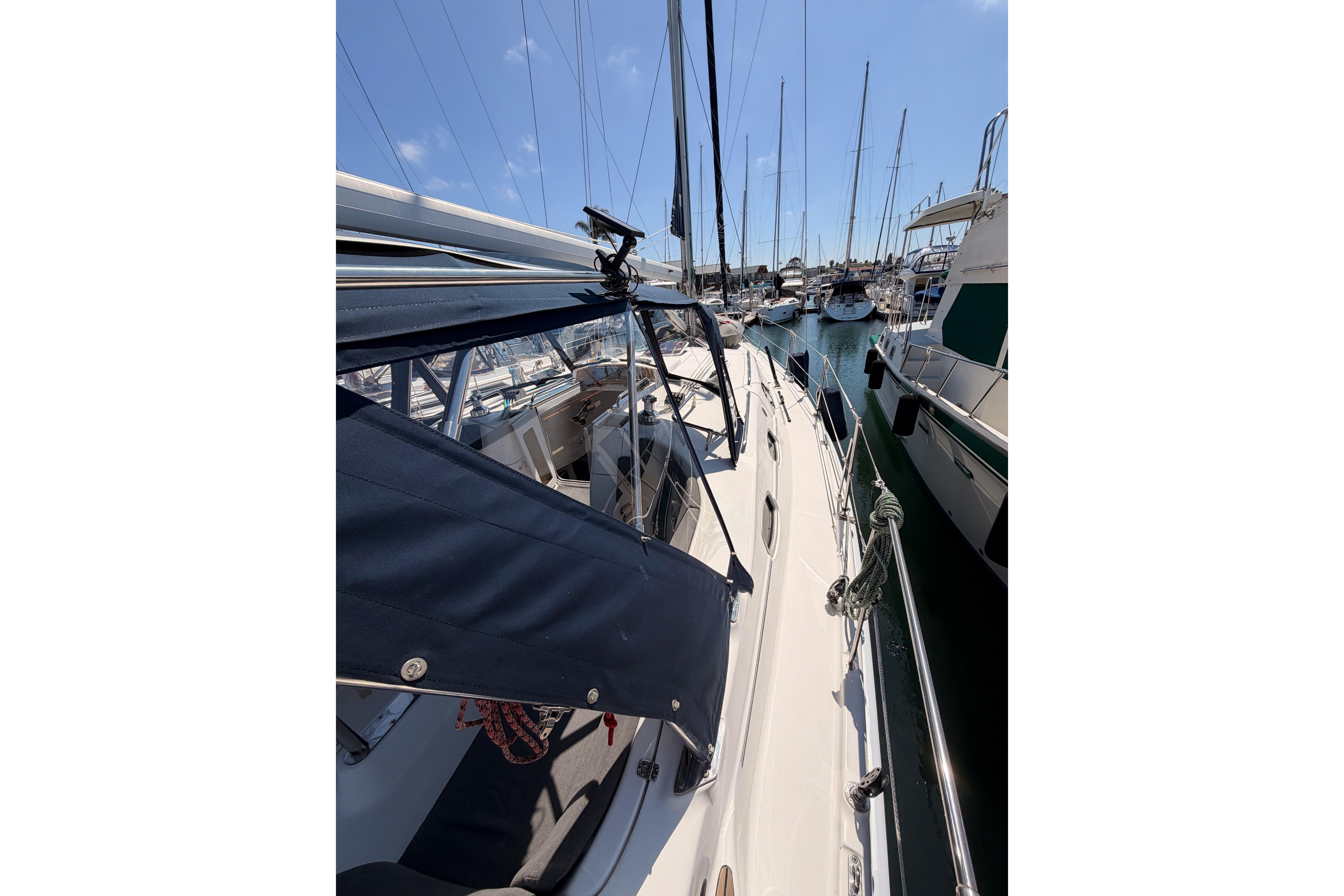 2008 Hunter 45 Deck Salon sailboat docked in a marina under clear blue skies.