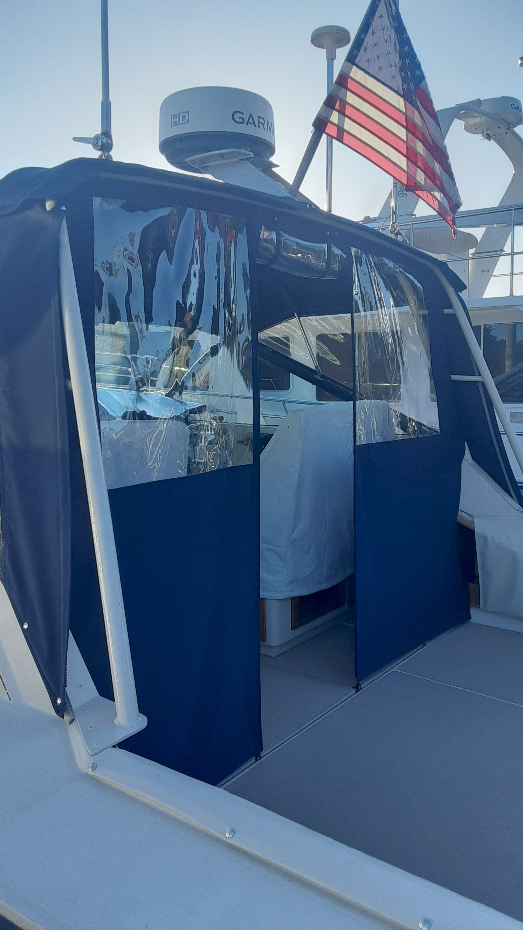 1985 Tiara Yachts 3100 Open with blue cover and US flag.