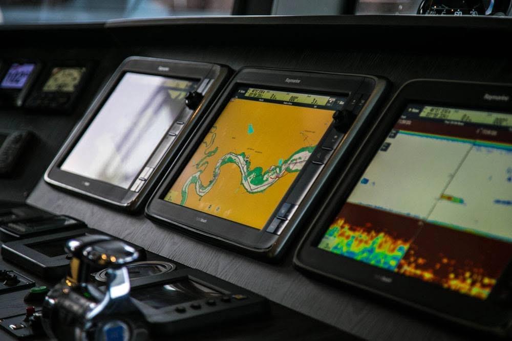 Control panel of 2014 Fifth Ocean Yachts 24m Explorer Yacht with navigation screens.