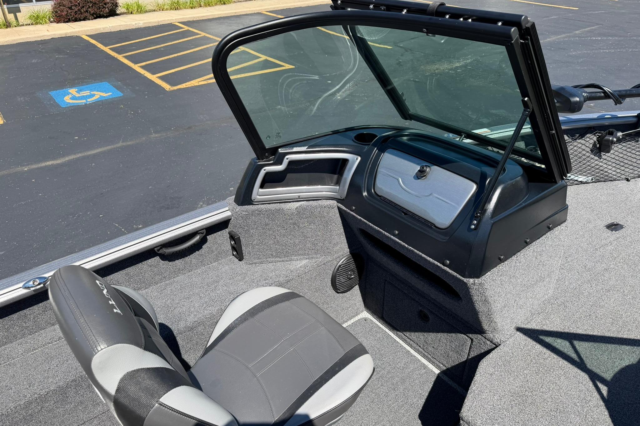 2024 Lund 1875 Impact XS Sport boat interior with seating and dashboard.