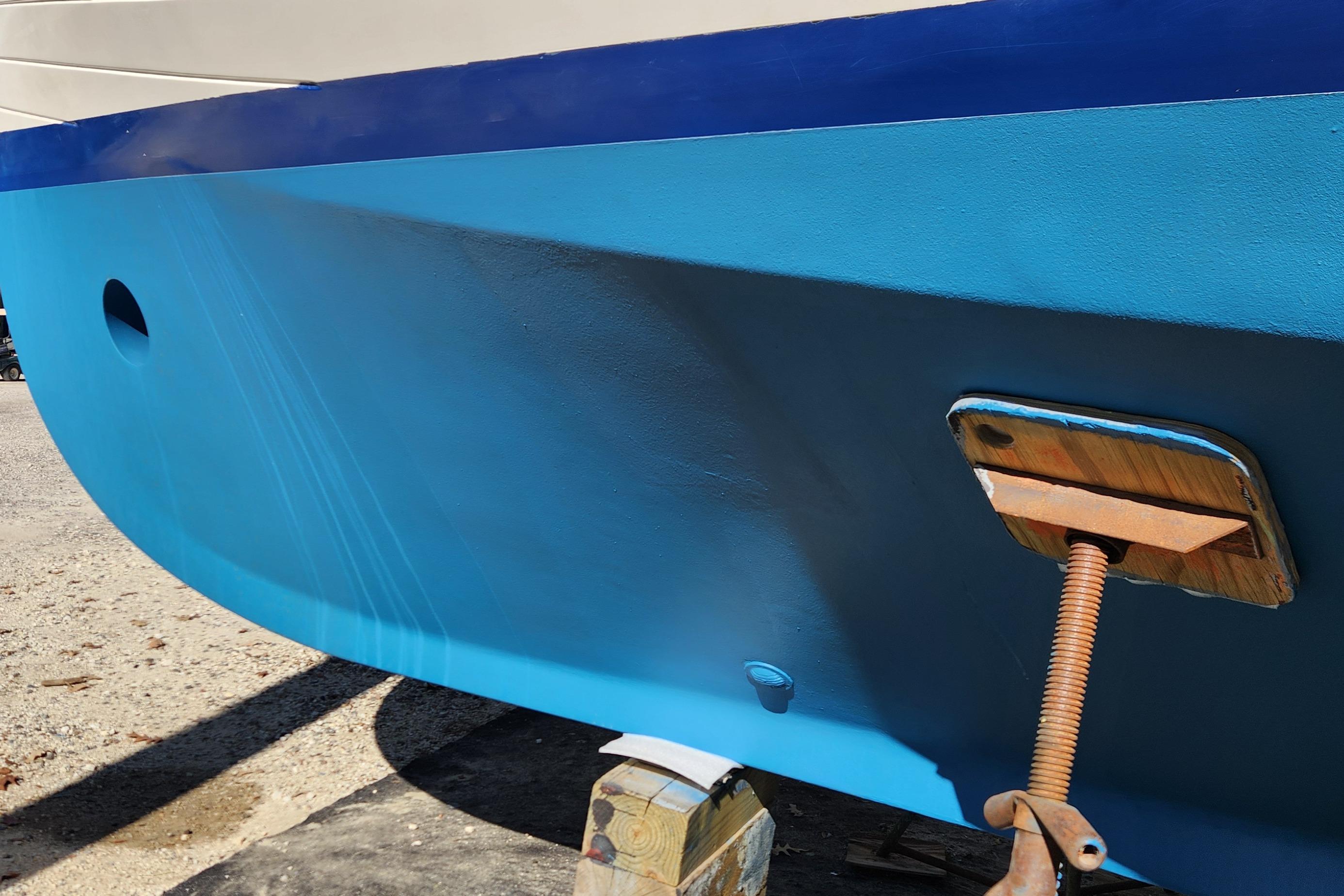 Blue hull of 1987 Grand Banks 36 Classic boat on dry dock.