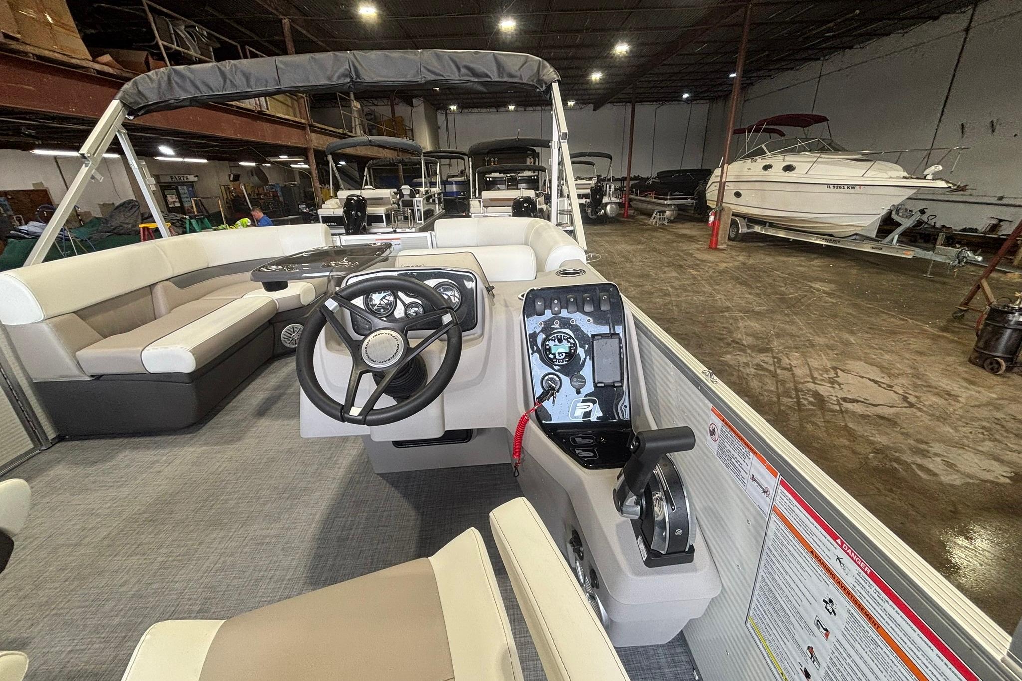 2025 Princecraft Vectra 21 RL pontoon boat interior with steering wheel and seating.