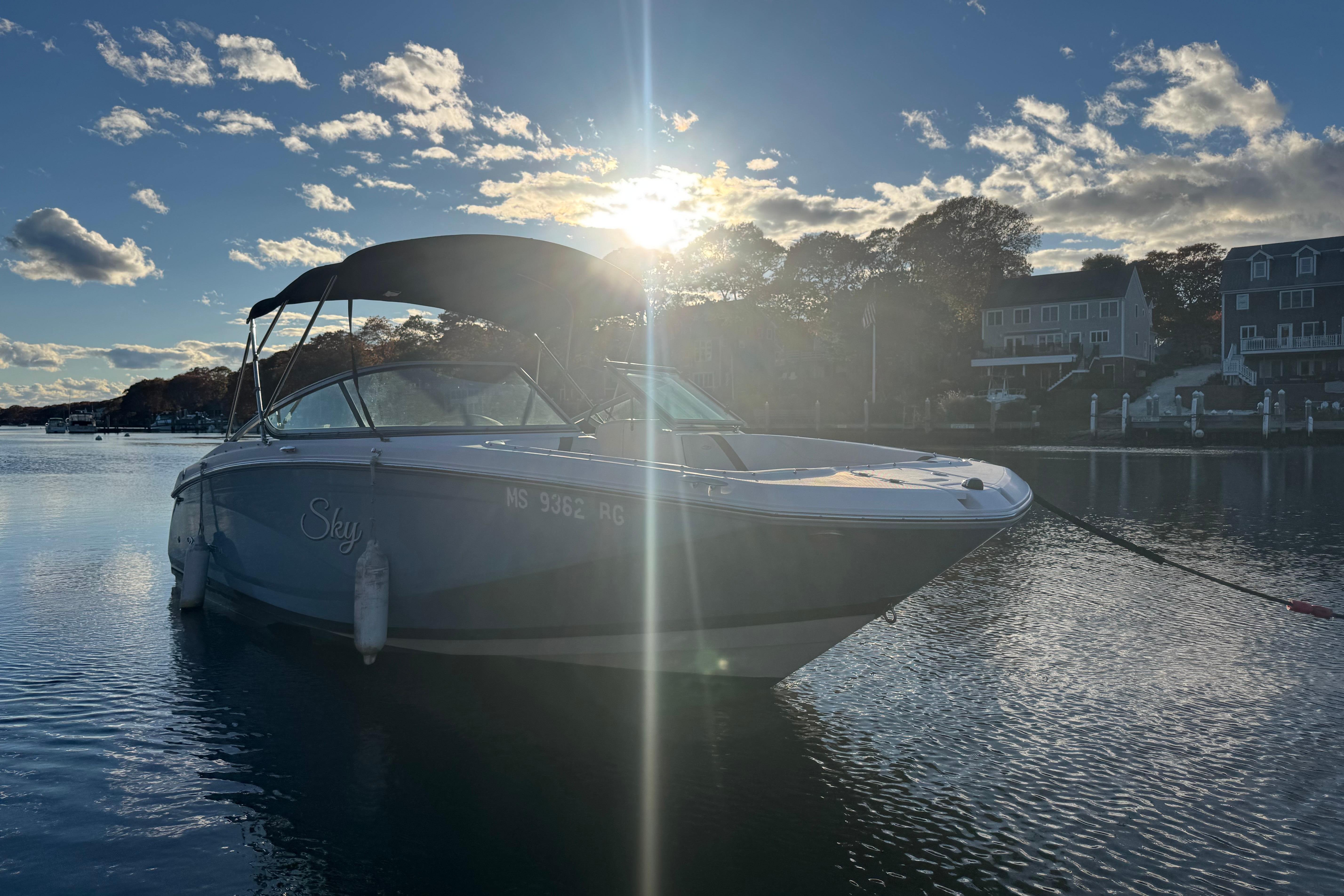 2017 Regal 23 OBX boat on calm water at sunset.