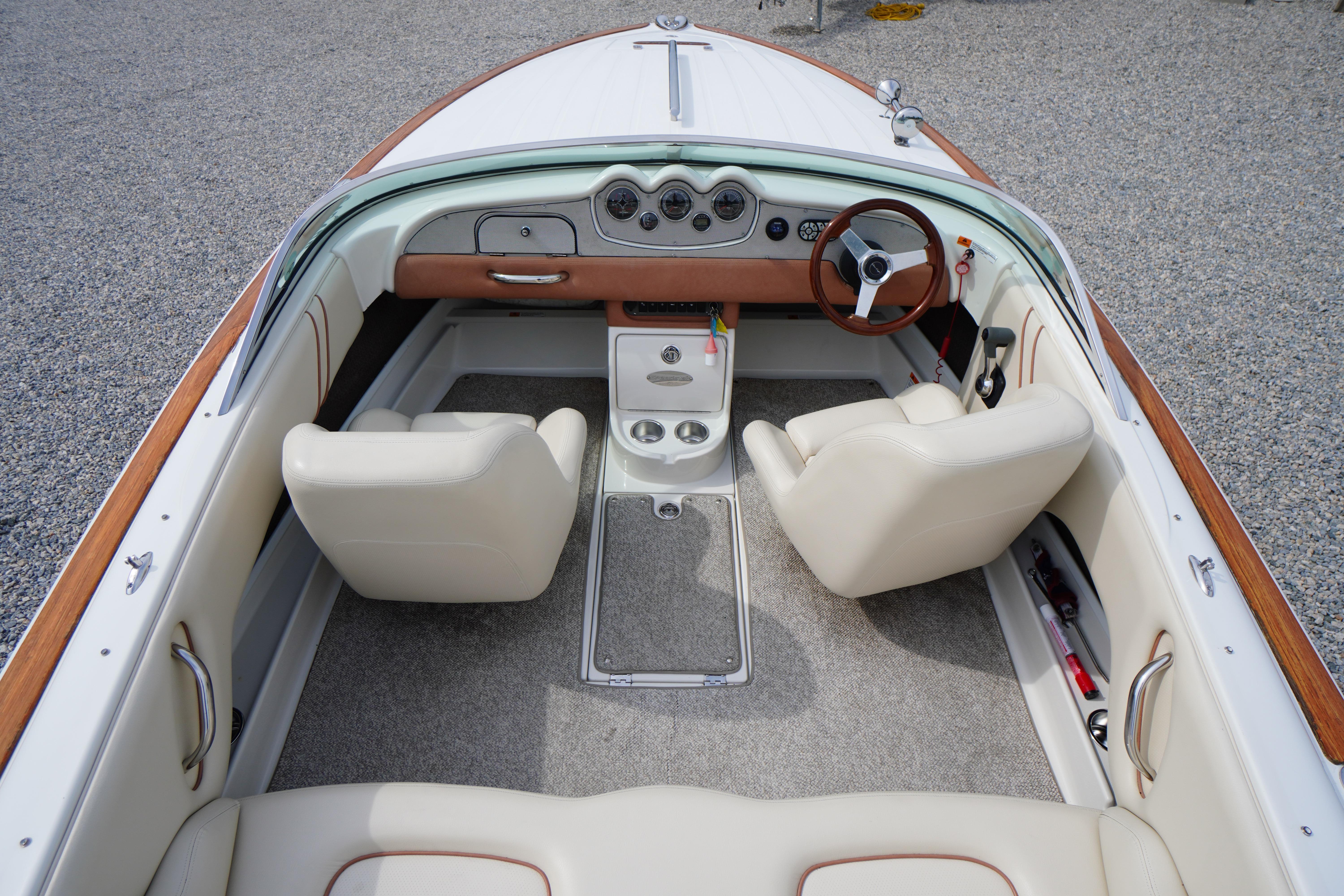 2005 Chris Craft Speedster Heritage boat interior with white leather seats and wooden accents.