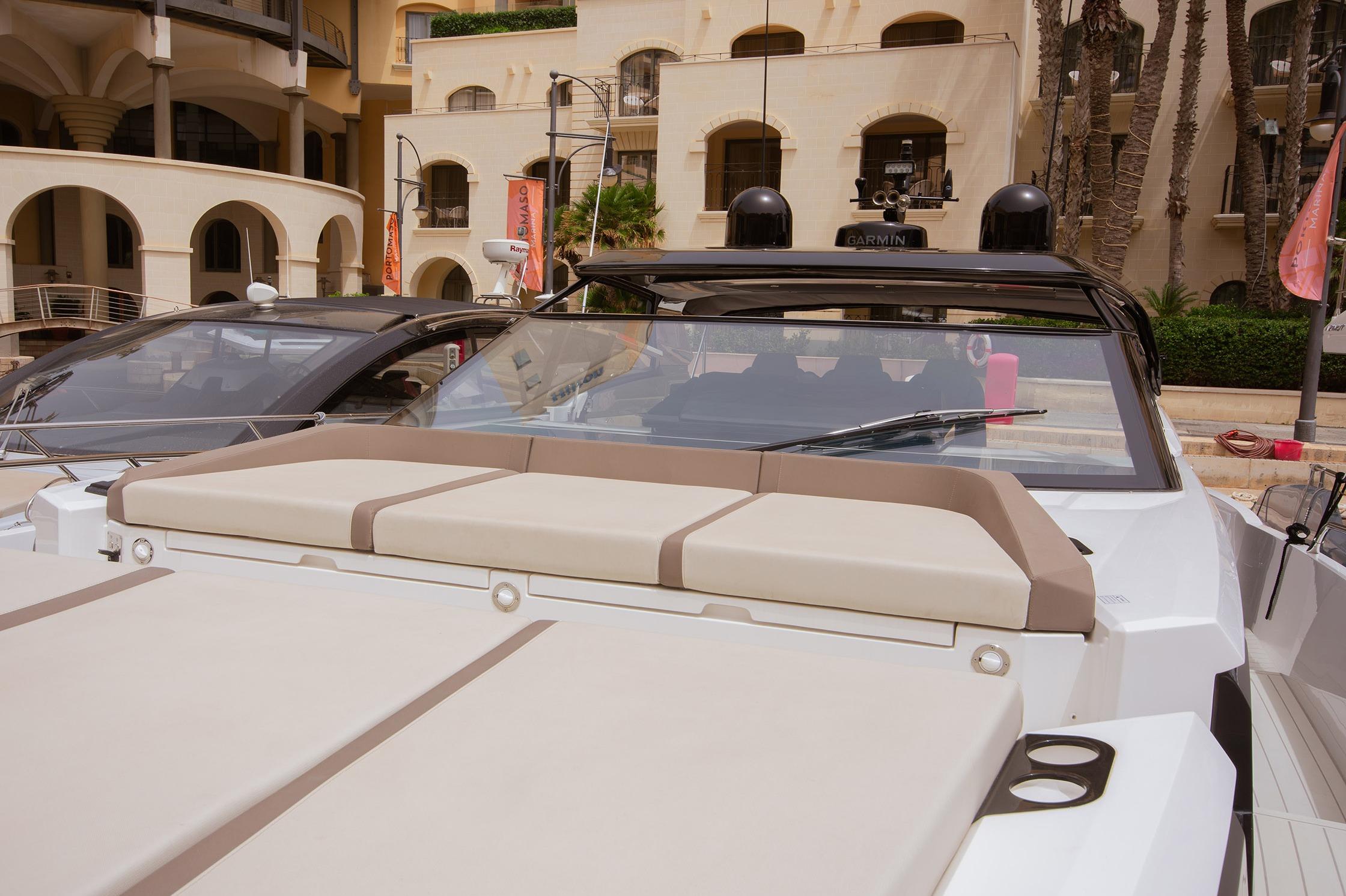 2024 Sunseeker Superhawk 55 luxury yacht docked at a marina, showcasing sleek design.