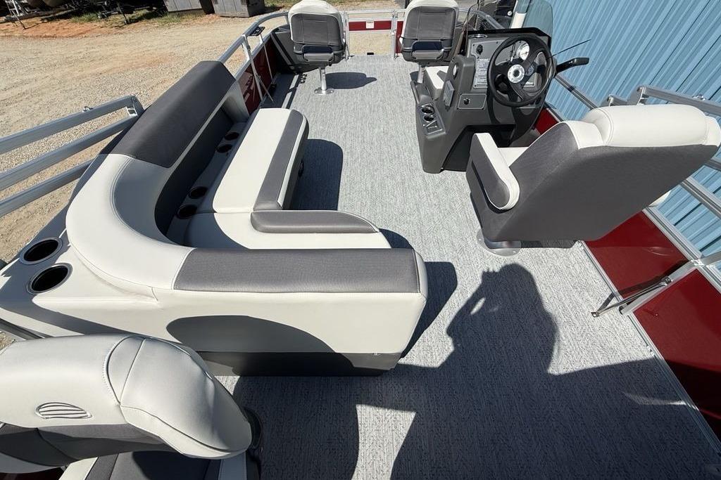 2026 Sun Tracker Bass Buggy 18 DLX pontoon boat interior with seating and steering console.