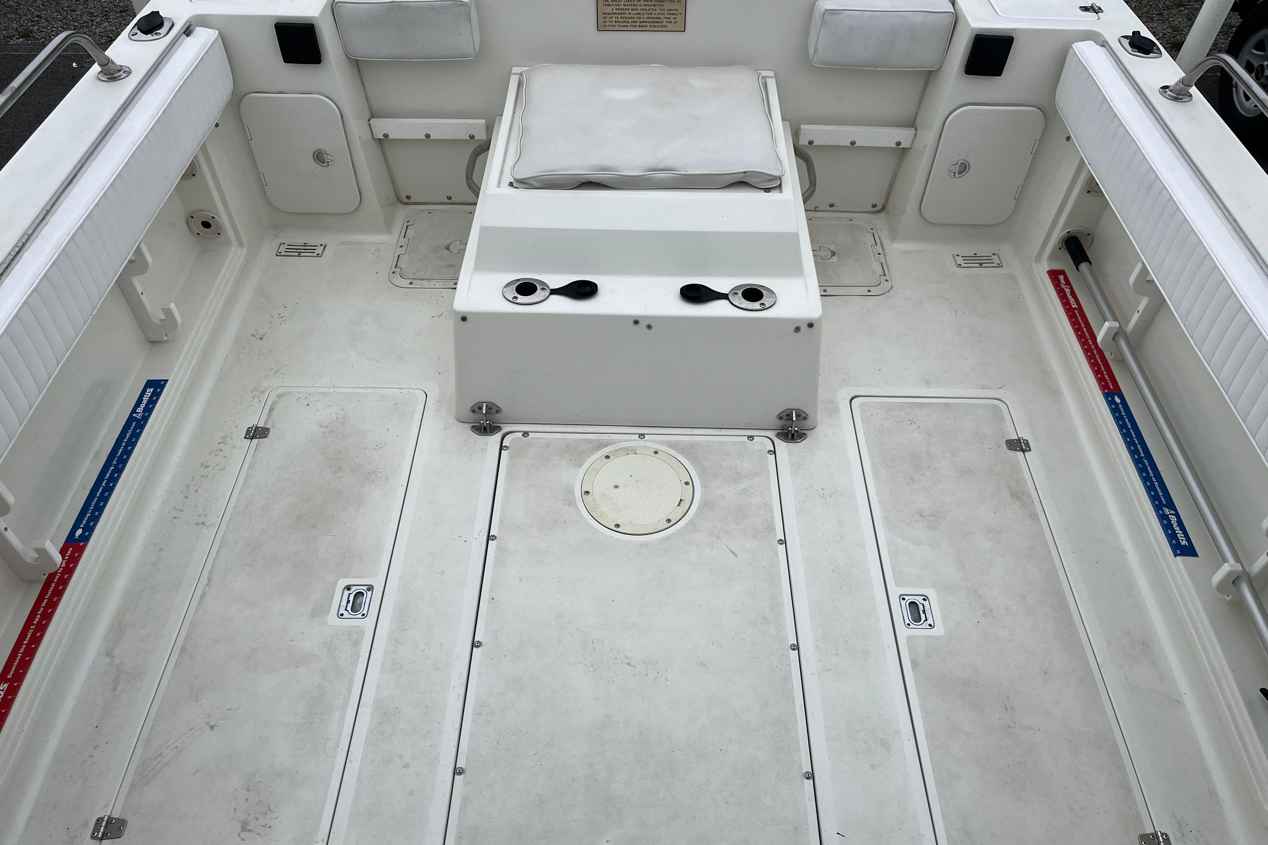 1995 Celebrity 2500 Fish Hawk boat interior with white seating and storage compartments.
