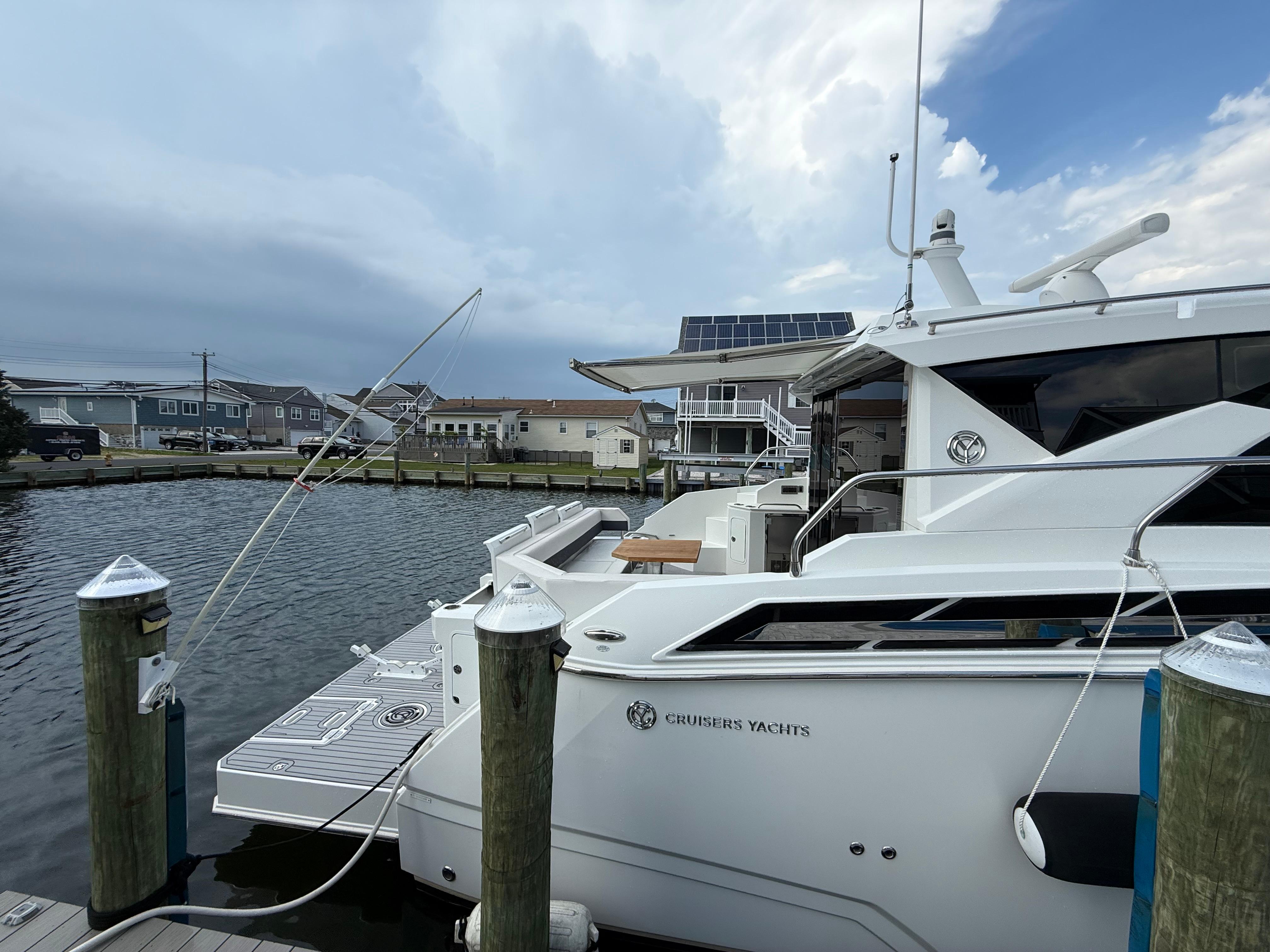 2018 Cruisers Yachts 42 Cantius docked at marina, overcast sky.
