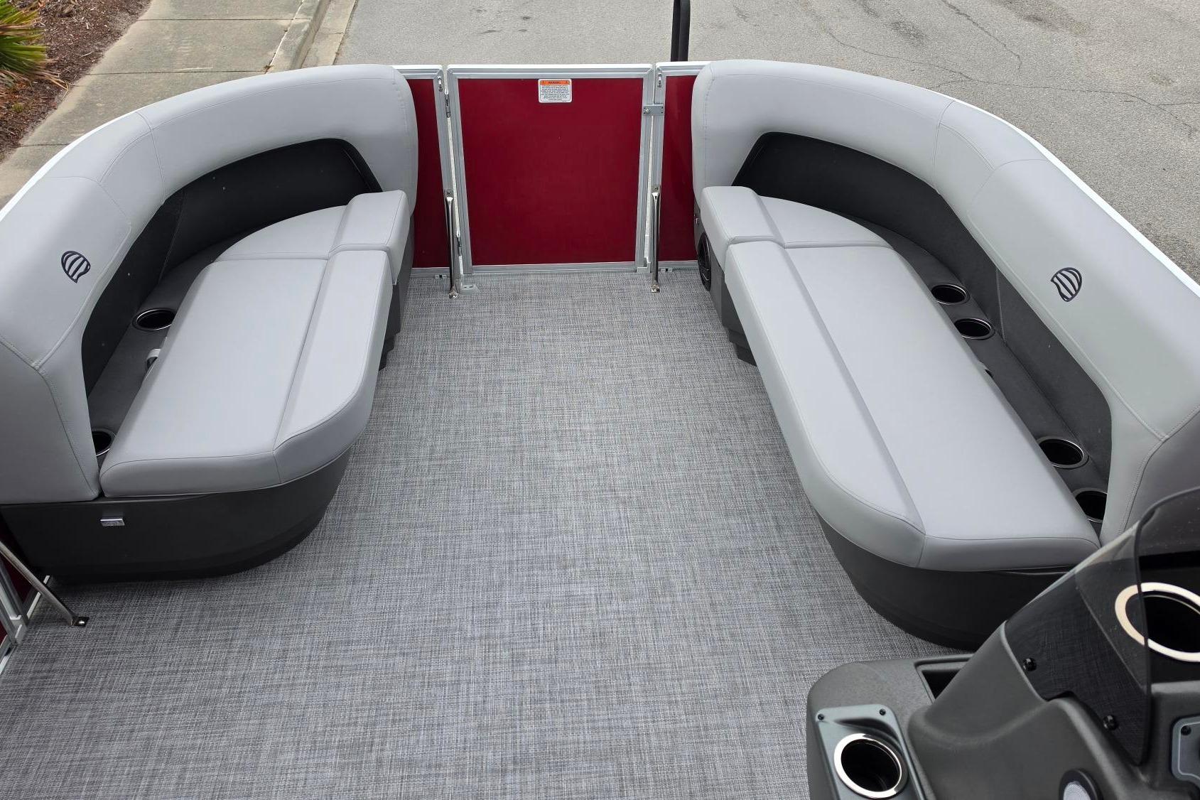 2026 Sun Tracker Party Barge 16 DLX interior with gray seating and cup holders.