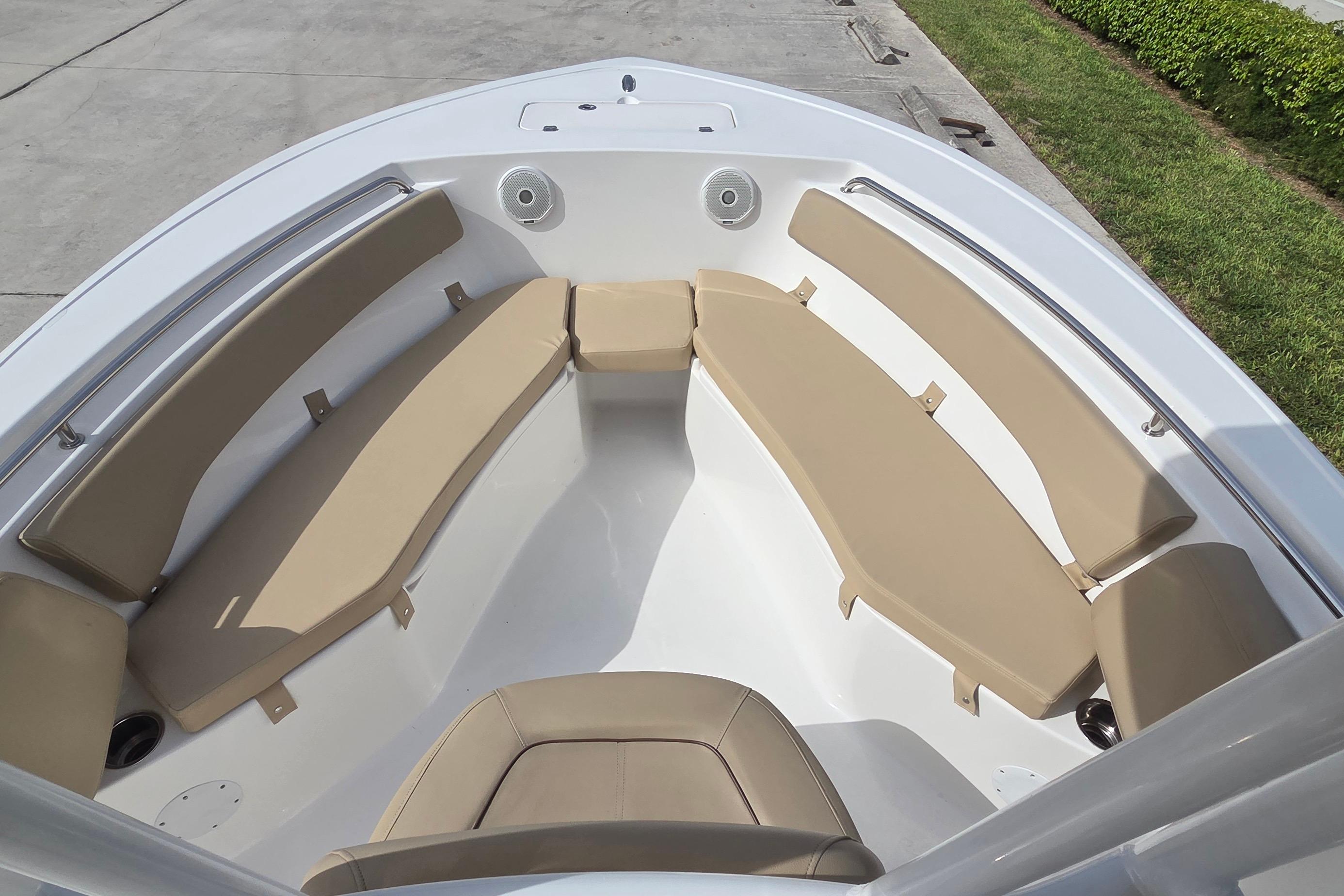2015 Tidewater 220 LXF boat interior with tan cushioned seating.
