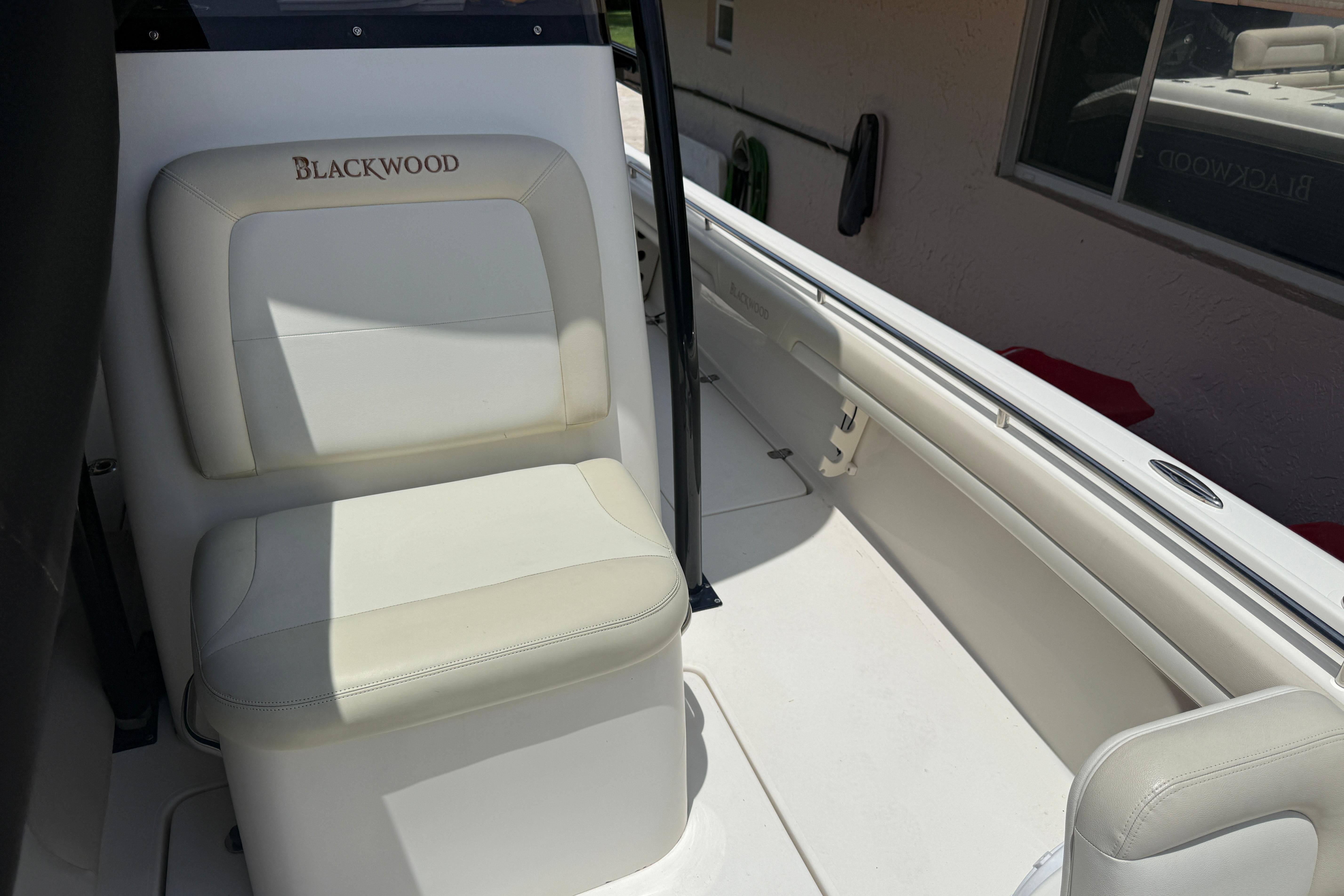 Interior of a 2015 Blackwood 27 boat featuring white seating and sleek design.