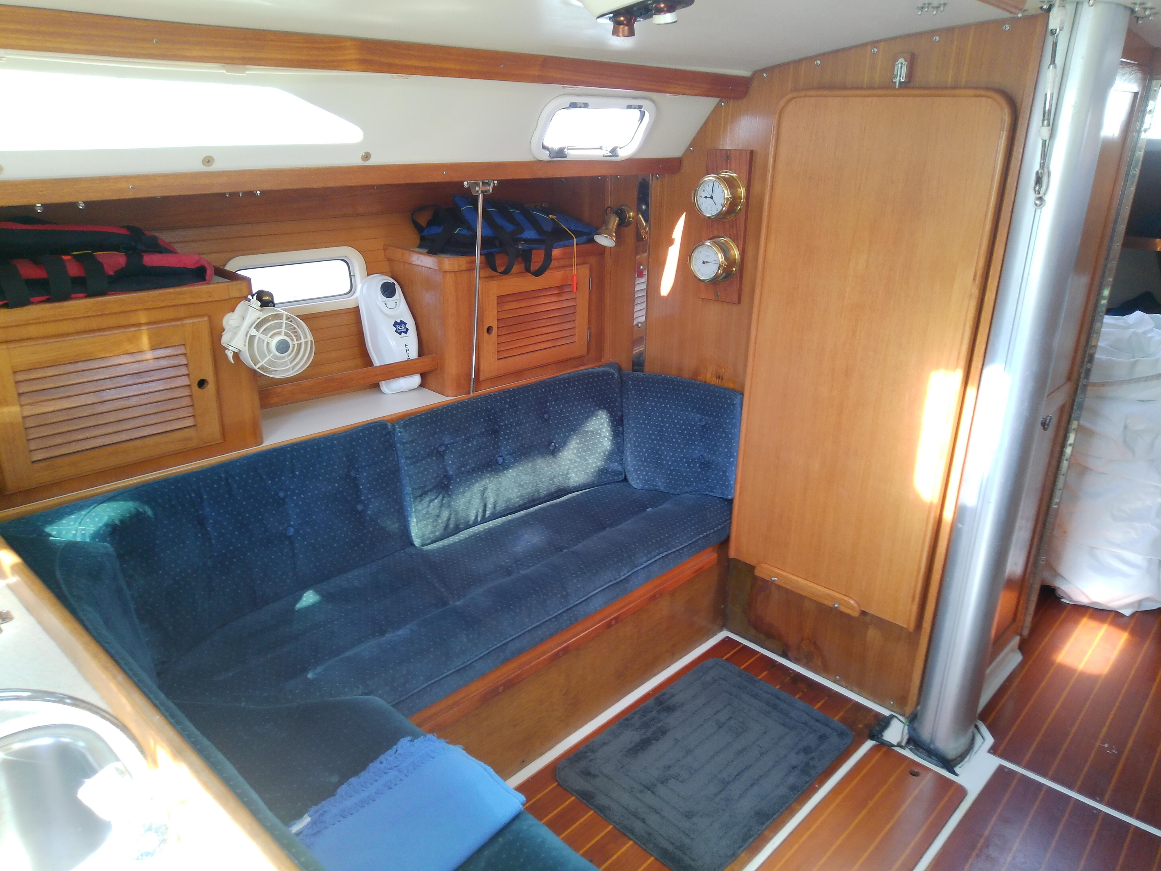 Interior of 1995 Catalina 36 MkII sailboat with blue seating and wooden finishes.
