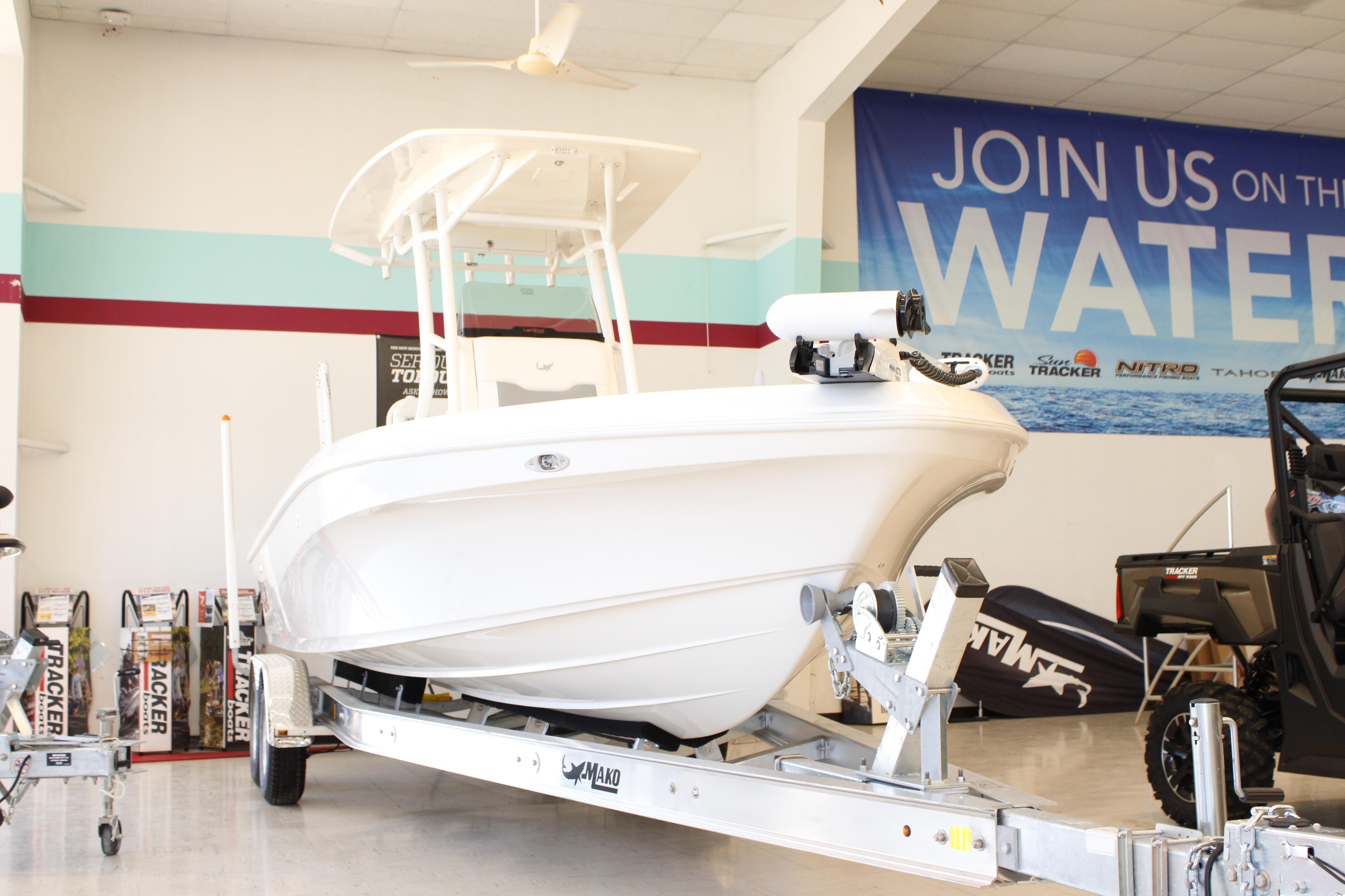 2026 Mako 24 APEX boat displayed indoors on a trailer.