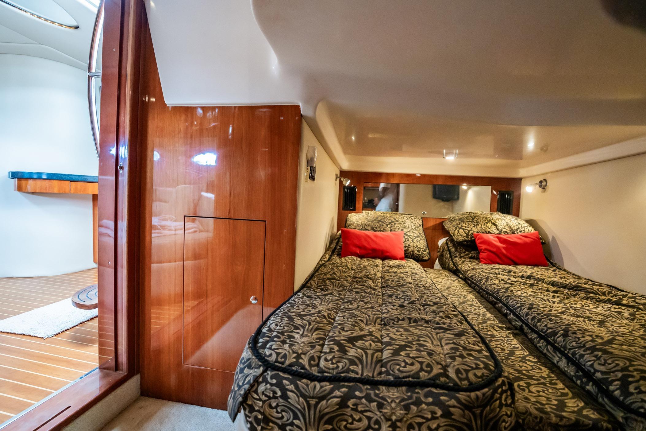 Luxurious 2008 Regal Commodore 4460 yacht cabin with twin beds and elegant decor.