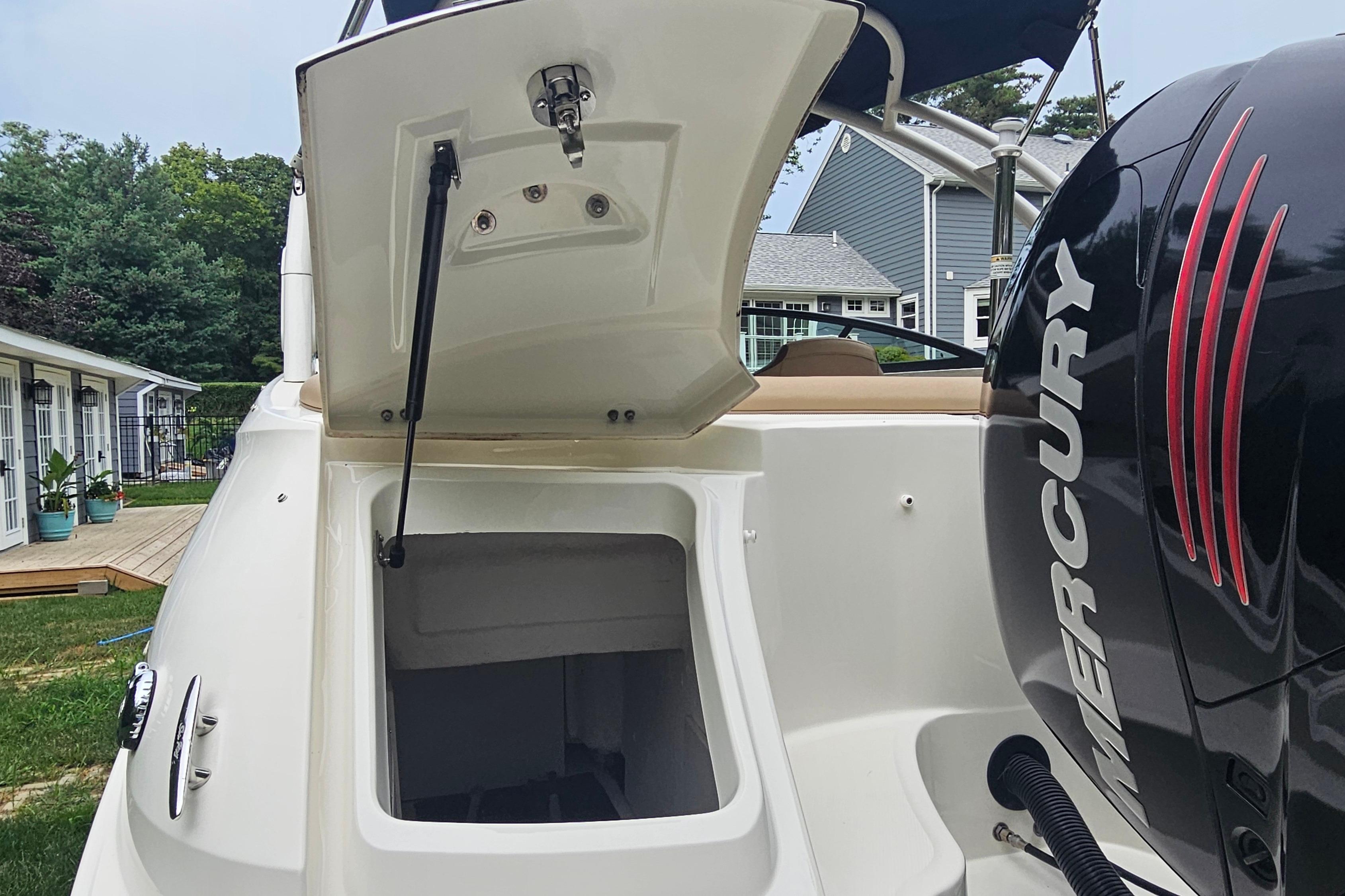 2017 Sea Ray SDX 240 Outboard with open storage compartment and Mercury engine.