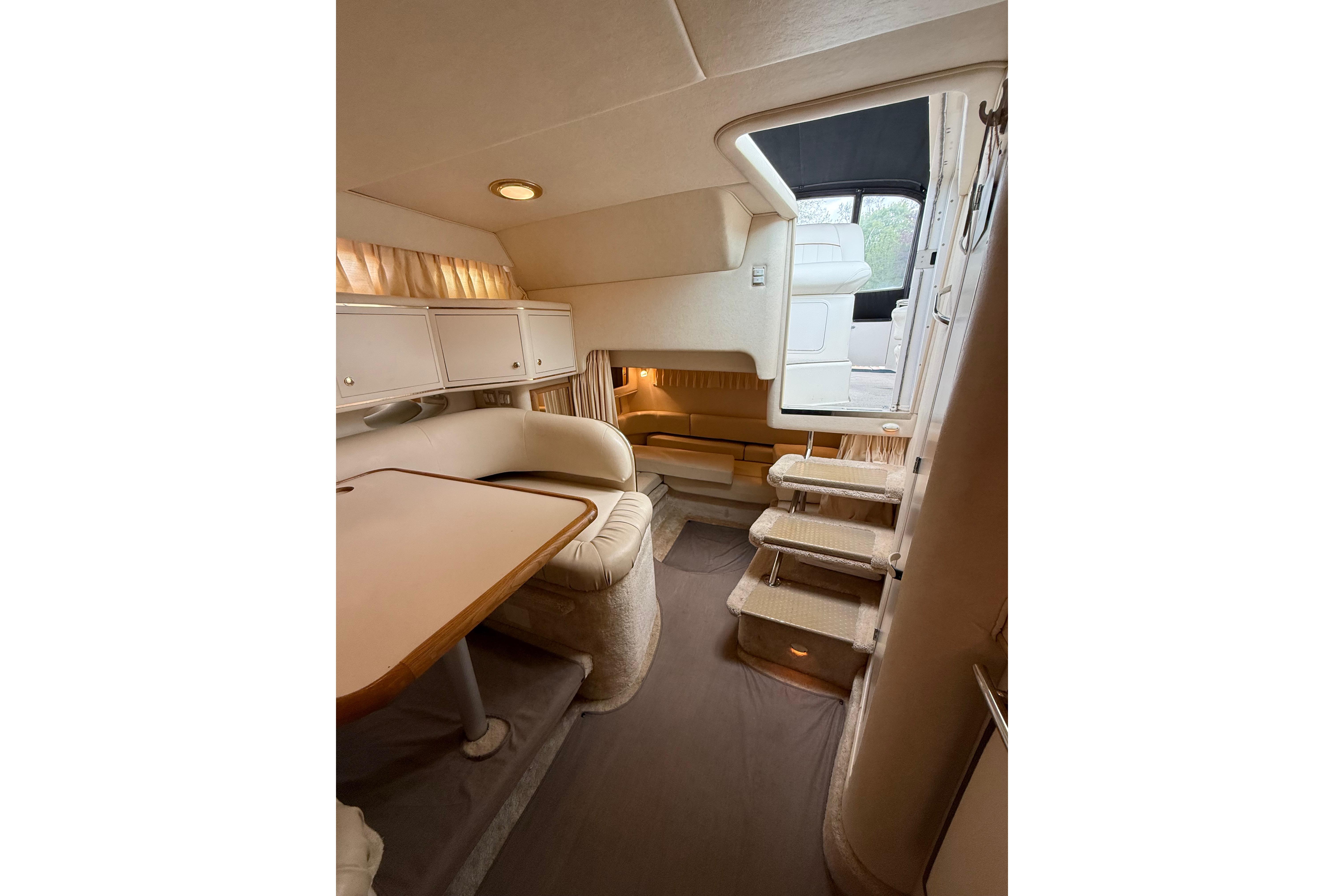 Interior of 1999 Sea Ray Sundancer 310 yacht, featuring cozy seating and elegant design.