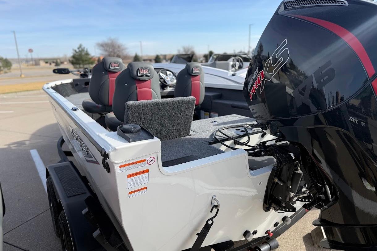 2026 Ranger VS1882SC Reata boat with powerful outboard motor in a parking lot.