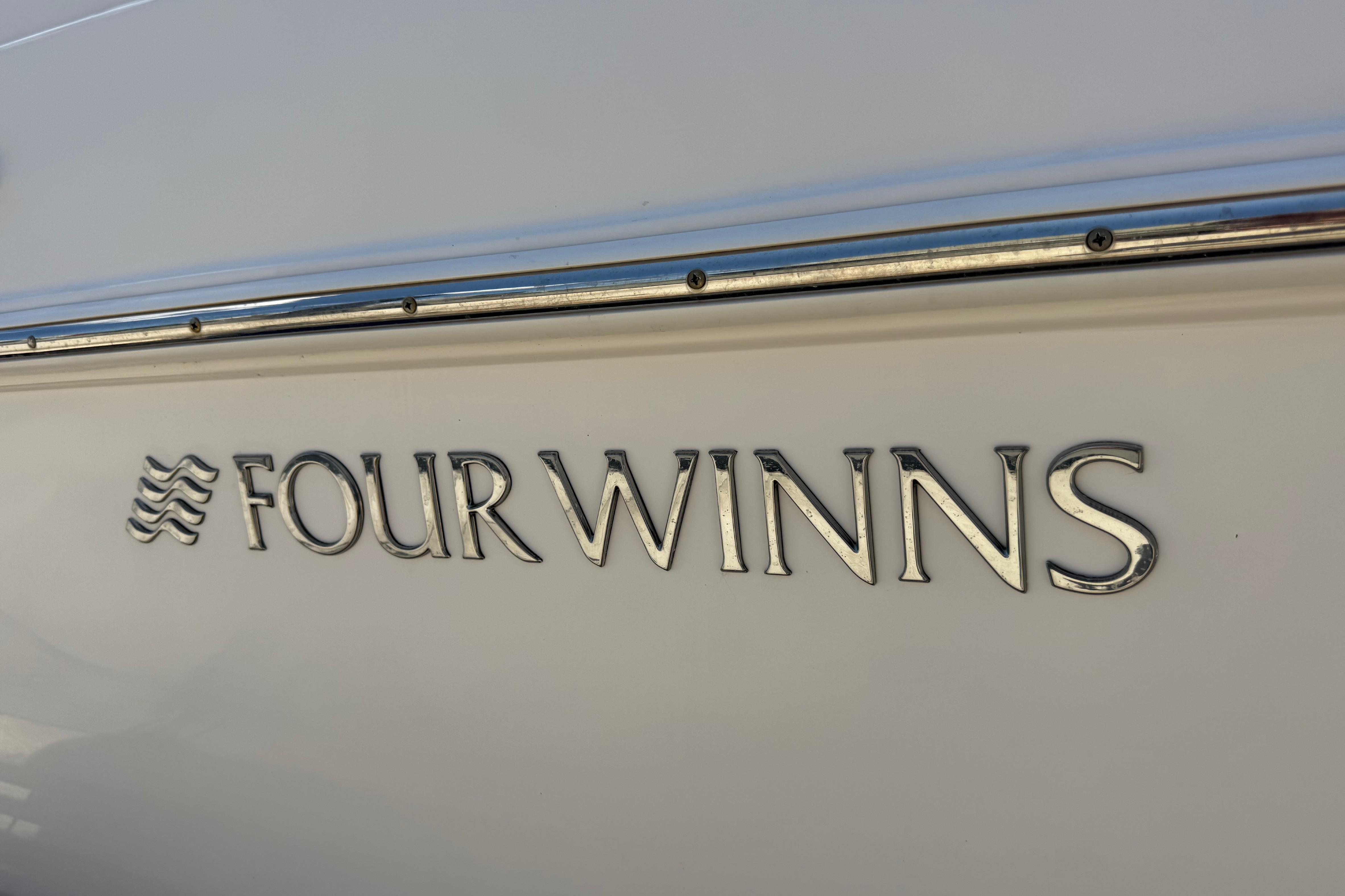 Four Winns V275 2017 boat logo on white hull.
